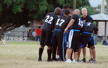 SOTO CANO AIR BASE, Honduras – Players from Soto Cano’s Army Forces flag football team huddle to discuss their next play during the Joint Task Force-Bravo Annual Turkey Bowl game, which pits Army Soldiers against Air Force Airmen in a friendly competition, Nov. 11.  The Air Force team beat the Army team 18-12.  (U.S. Air Force photo by Staff Sgt. Austin M. May)