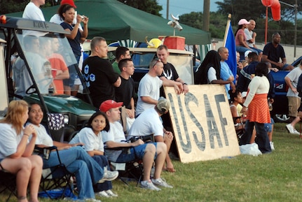 SOTO CANO AIR BASE, Honduras – Supporters from various units on Soto Cano gather on the sidelines of the base soccer field to cheer on their respective teams during the Joint Task Force-Bravo Annual Turkey Bowl flag football game, in which Army Soldiers take on Air Force Airmen.  The Air Force team beat the Army team 18-12.  (U.S. Air Force photo by Staff Sgt. Austin M. May)