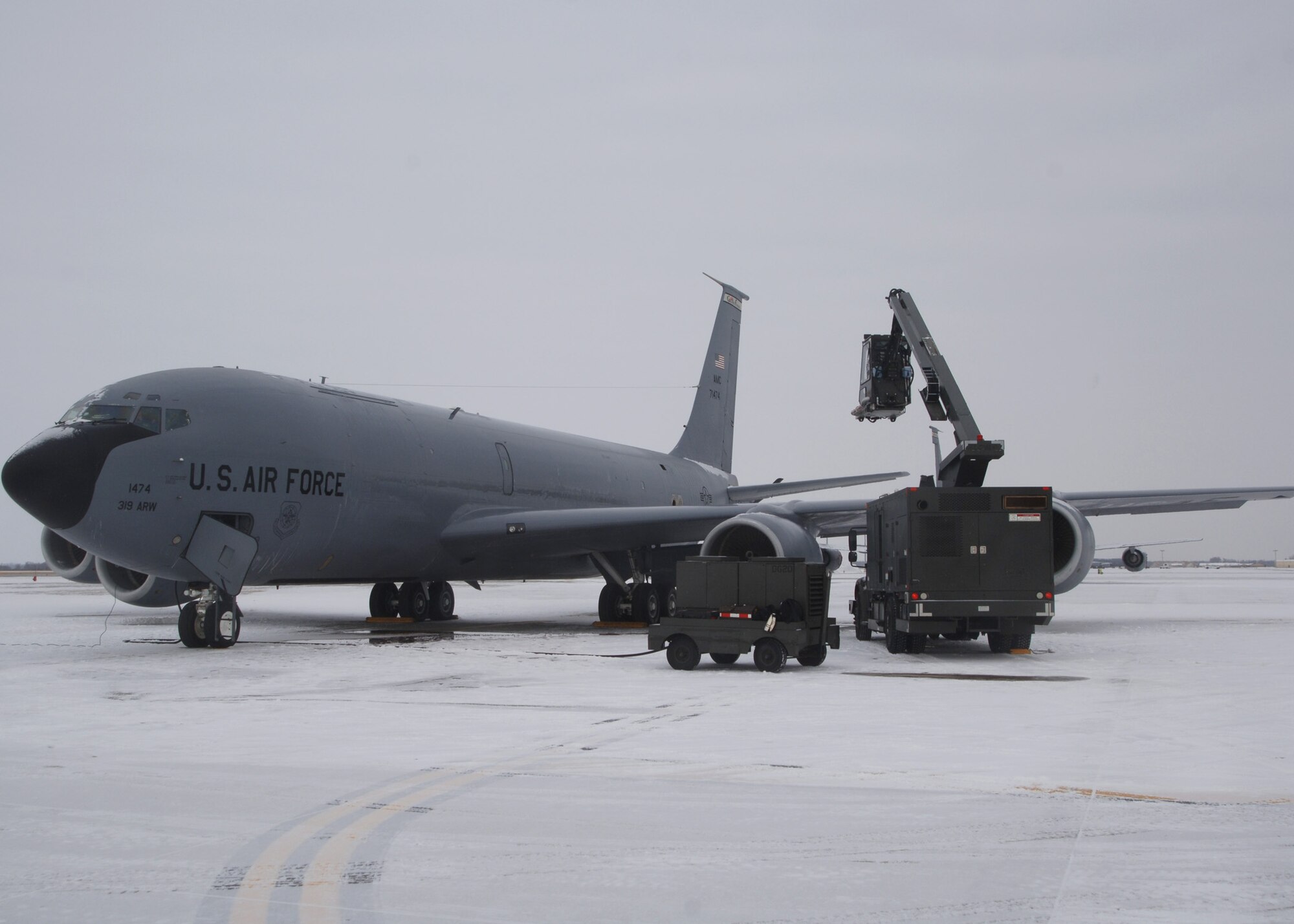 KC-135 Stratotanker gets prepared for an exercise mission by a deicer on the flight line at Grand Forks Air Force Base, North Dakota on November 28, 2007. The base is undergoing a strategic exercise in the -12 degree weather, -20 degree wind chill, a typical North Dakota day in the winter months. (U.S. Air Force photo/Senior Airman Chad M. Kellum)(Released)
