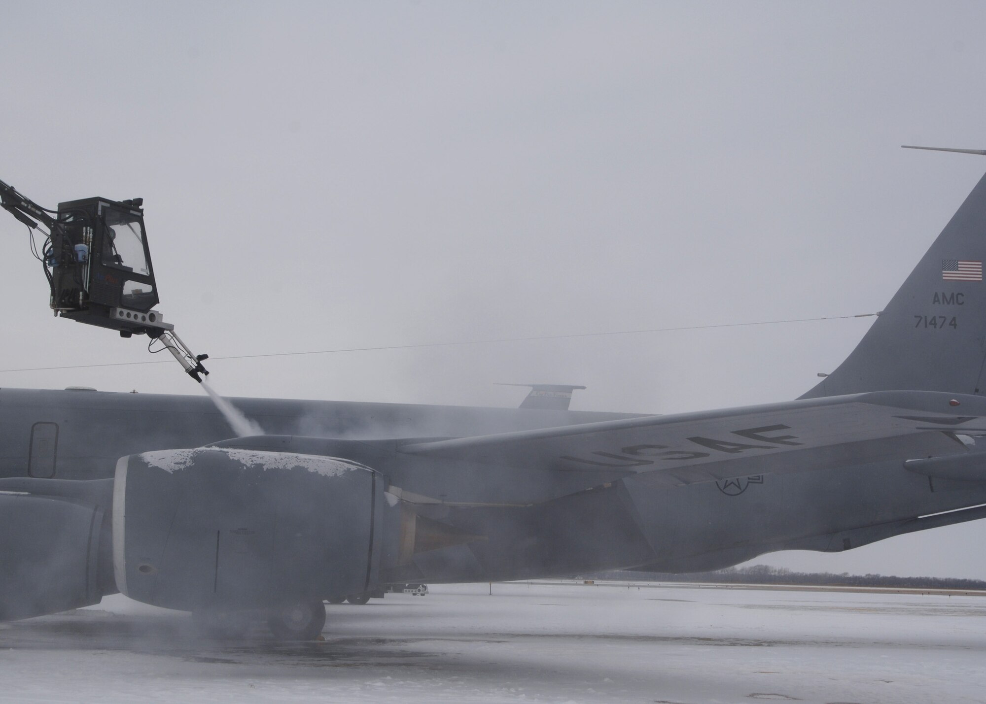 KC-135 Stratotanker gets prepared for an exercise mission by a deicer on the flight line at Grand Forks Air Force Base, North Dakota on November 28, 2007. The base is undergoing a strategic exercise in the -12 degree weather, -20 degree wind chill, a typical North Dakota day in the winter months. (U.S. Air Force photo/Senior Airman Chad M. Kellum)