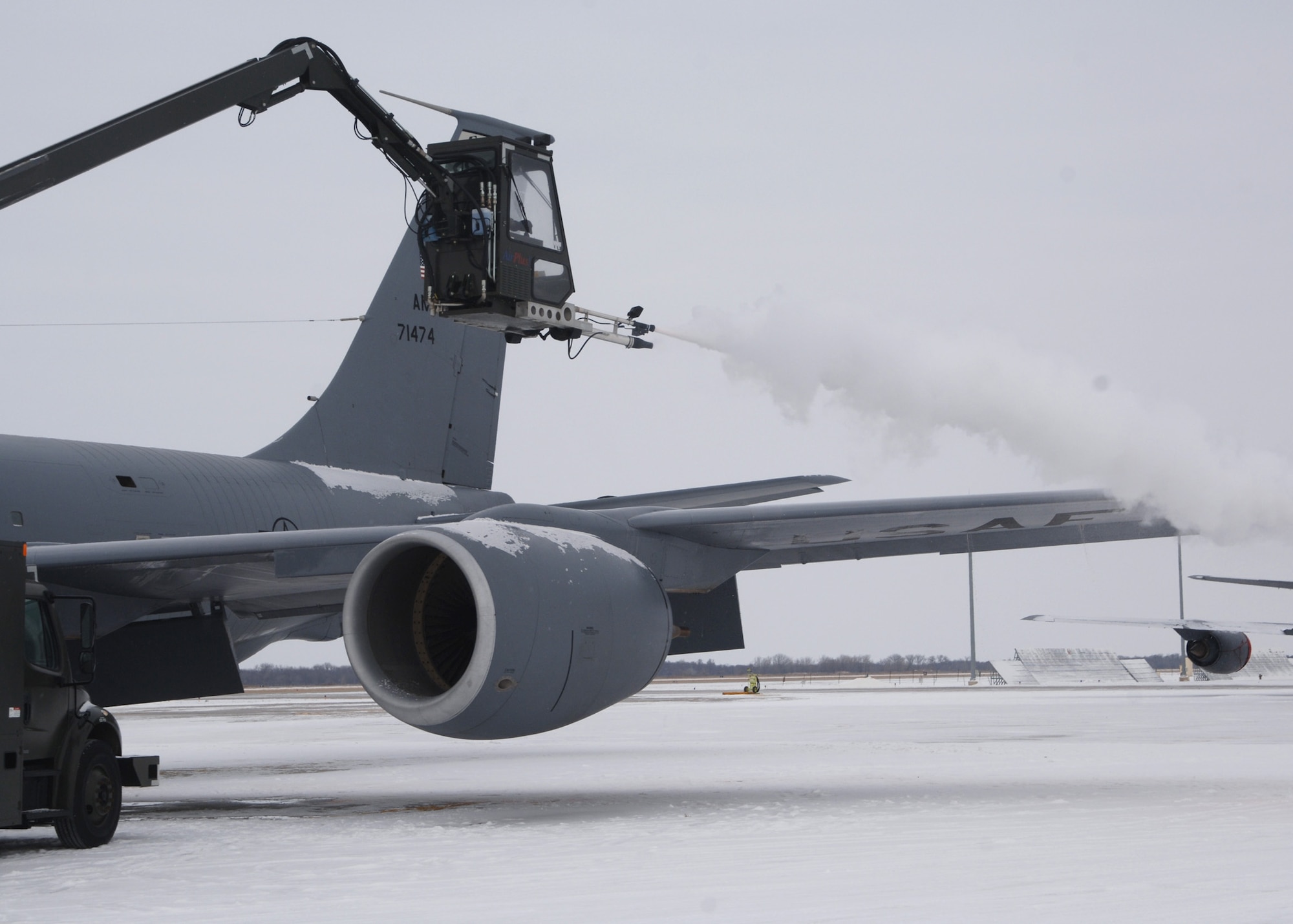 KC-135 Stratotanker gets prepared for an exercise mission by a deicer on the flight line at Grand Forks Air Force Base, North Dakota on November 28, 2007. The base is undergoing a strategic exercise in the -12 degree weather, -20 degree wind chill, a typical North Dakota day in the winter months. (U.S. Air Force photo by Senior Airman Chad M. Kellum)