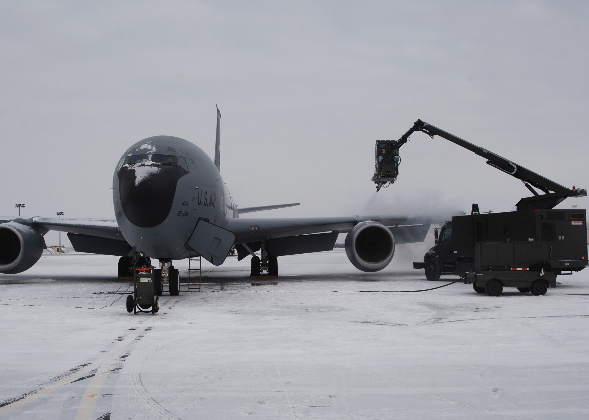 KC-135 Stratotanker gets prepared for an exercise mission by a deicer on the flight line at Grand Forks Air Force Base, North Dakota on November 28, 2007. The base is undergoing a strategic exercise in the -12 degree weather, -20 degree wind chill, a typical North Dakota day in the winter months. (U.S. Air Force photo by Senior Airman Chad M. Kellum)