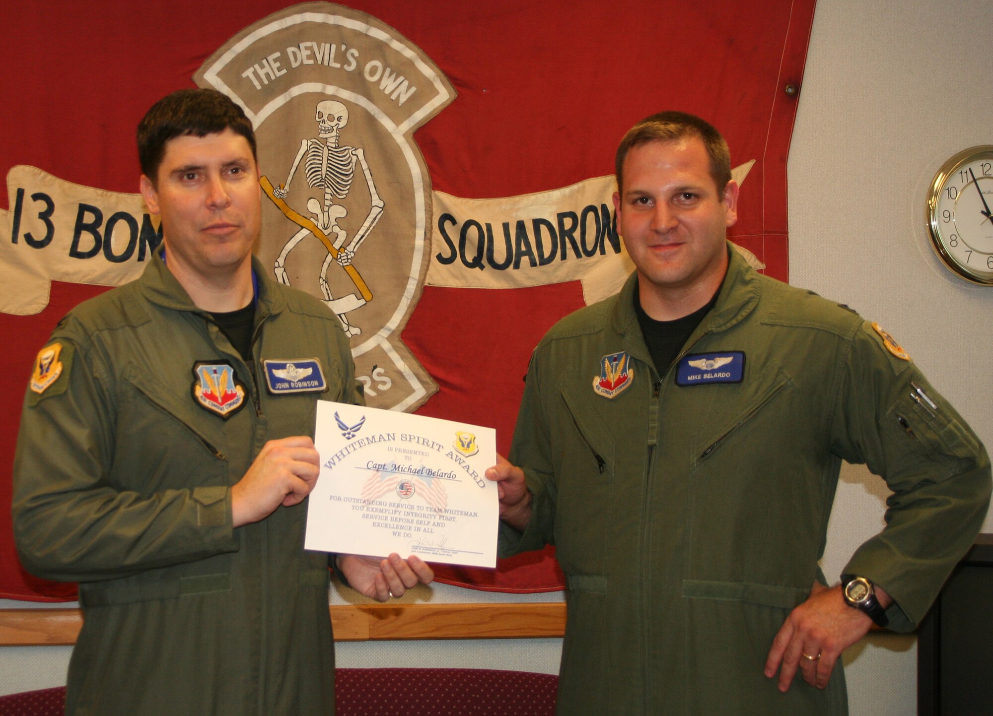 WHITEMAN AIR FORCE BASE, Mo. -- Col. John Robinson, 509th Bomb Wing vice commander, presents the Whiteman Spirit Award to Capt. Michael Belardo, 13th Bomb Sqaudron, Nov. 19. (U.S. Air Force photo/1st Lt. Candace Cutrufo) 