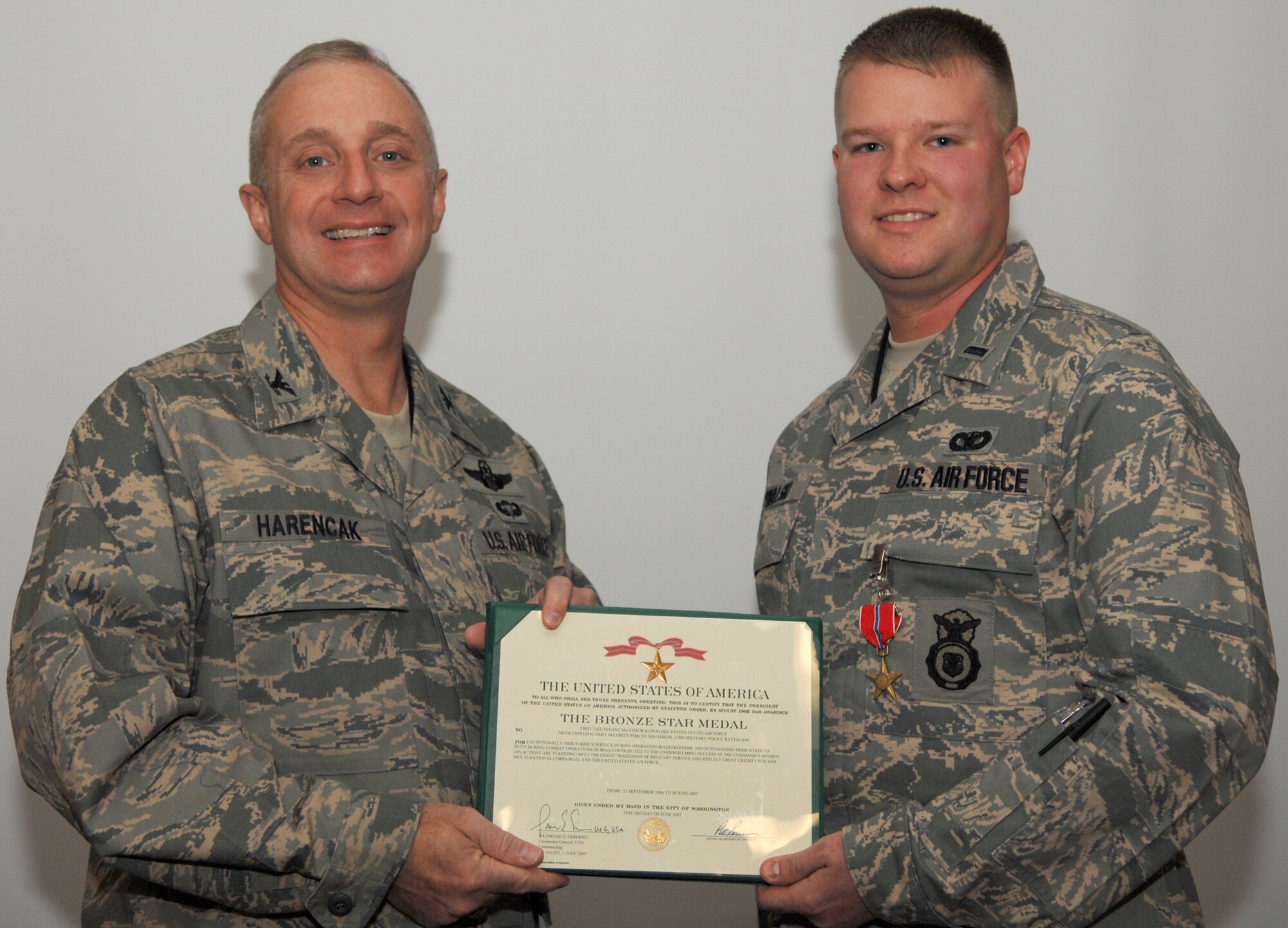 WHITEMAN AIR FORCE BASE, Mo. – 1st Lt. Matthew Kowalski, 509th Security Forces Squadron, receives a bronze star medal from Col. Garrett Harencak, 509th Bomb Wing commander, Nov. 28. (U.S. Air Force photo/Airman 1st Class Jessica M. Snow)