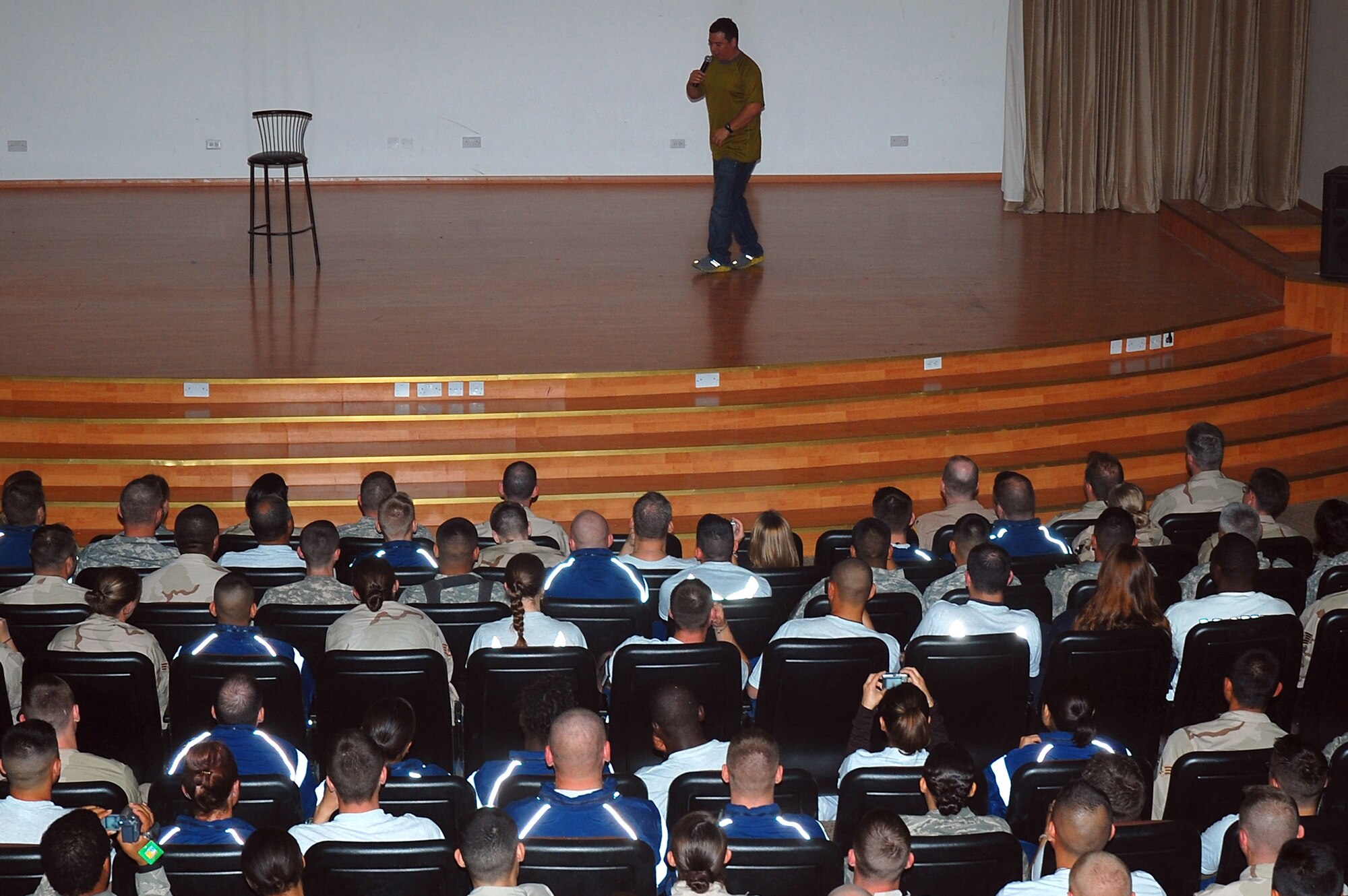 SOUTHWEST ASIA -- Comedian Carlos Mencia entertains members of the 386th Air Expeditionary Wing here Nov. 28.  Mr. Mencia and his crew traveled throughout the Middle East providing entertainment for deployed servicemembers.  (U.S. Air Force photo/Staff Sgt. Tia Schroeder)