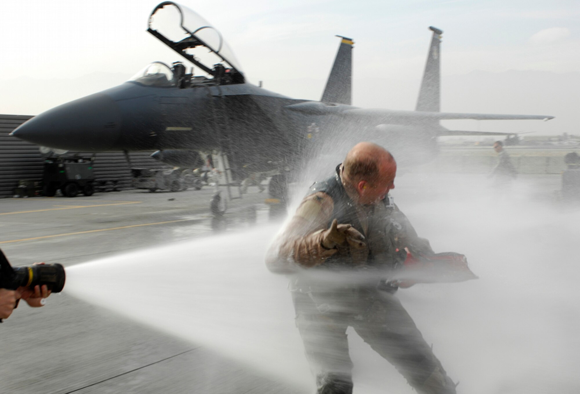 BAGRAM AIR BASE, Afghanistan -- Col. Eric Nelson, 455th Expeditionary Operations Group commander, receives the traditional greeting upon return from his last F-15E Strike Eagle flight here, Nov. 28, 2007.  Command of the 455th EOG will change hands on Dec. 5, with Col. Nelson returning to his stateside duties as commander of the 4th Operations Group at Seymour Johnson Air Force Base, N.C. (U.S. Air Force photo by Staff Sgt. Joshua Jasper)