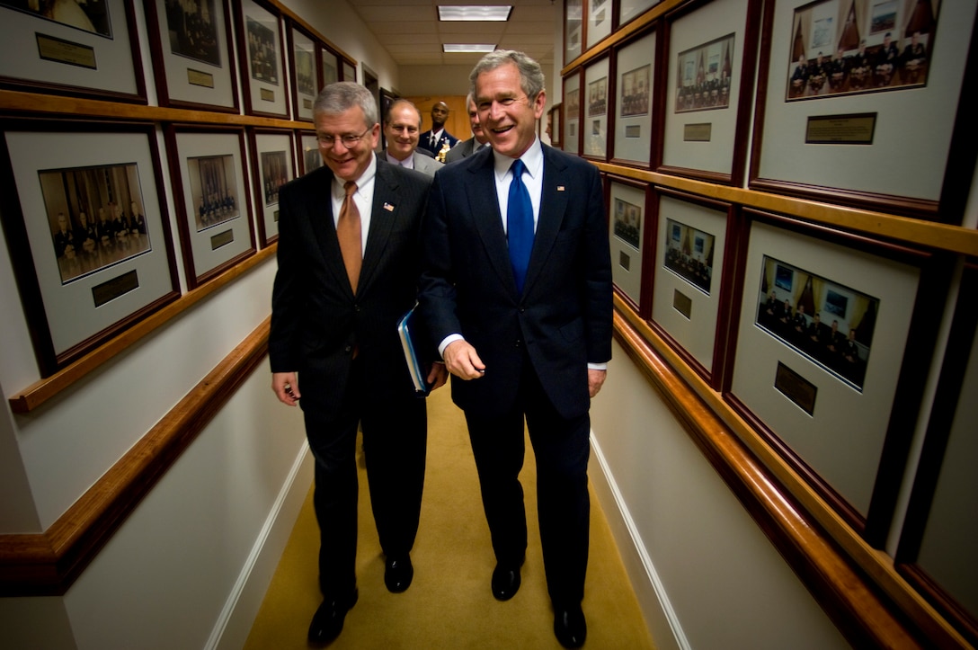 President George W. Bush, right, and Josh Bolton, White House chief of staff depart after a meeting with senior military leaders discussing long-term strategic plans for the military. 