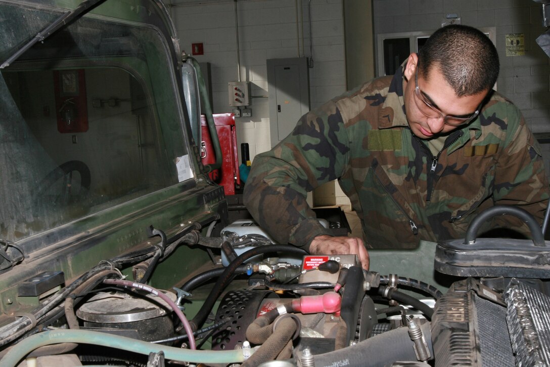 MARINE CORPS AIR STATION MIRAMAR, Calif. - Pfc. Giovanni Solis, a native of Calexico, Calif., a mechanic with Marine Wing Support Squadron 373, prepares to drain the power steering fluid from a humvee here Nov. 29.  Solis changed the fluid as part of the vehicle's corrective maintenance. (U.S. Marine Corps photo by rank Lance Cpl. Austin Goacher) (Released).
