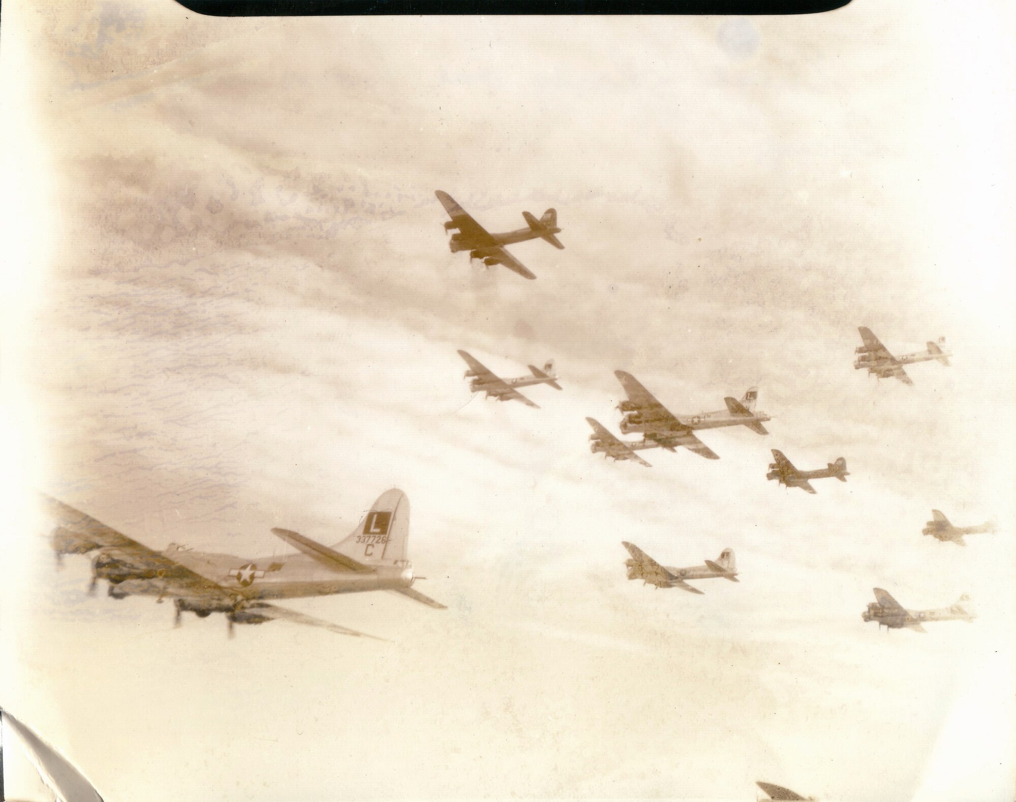 The B17 flying in the foreground is part of the 452nd Bombardment Group. Seen here flying with other aircraft, the 452nd planes were identified by the boxed L on their tail. (U.S. Army Air Forces photo)