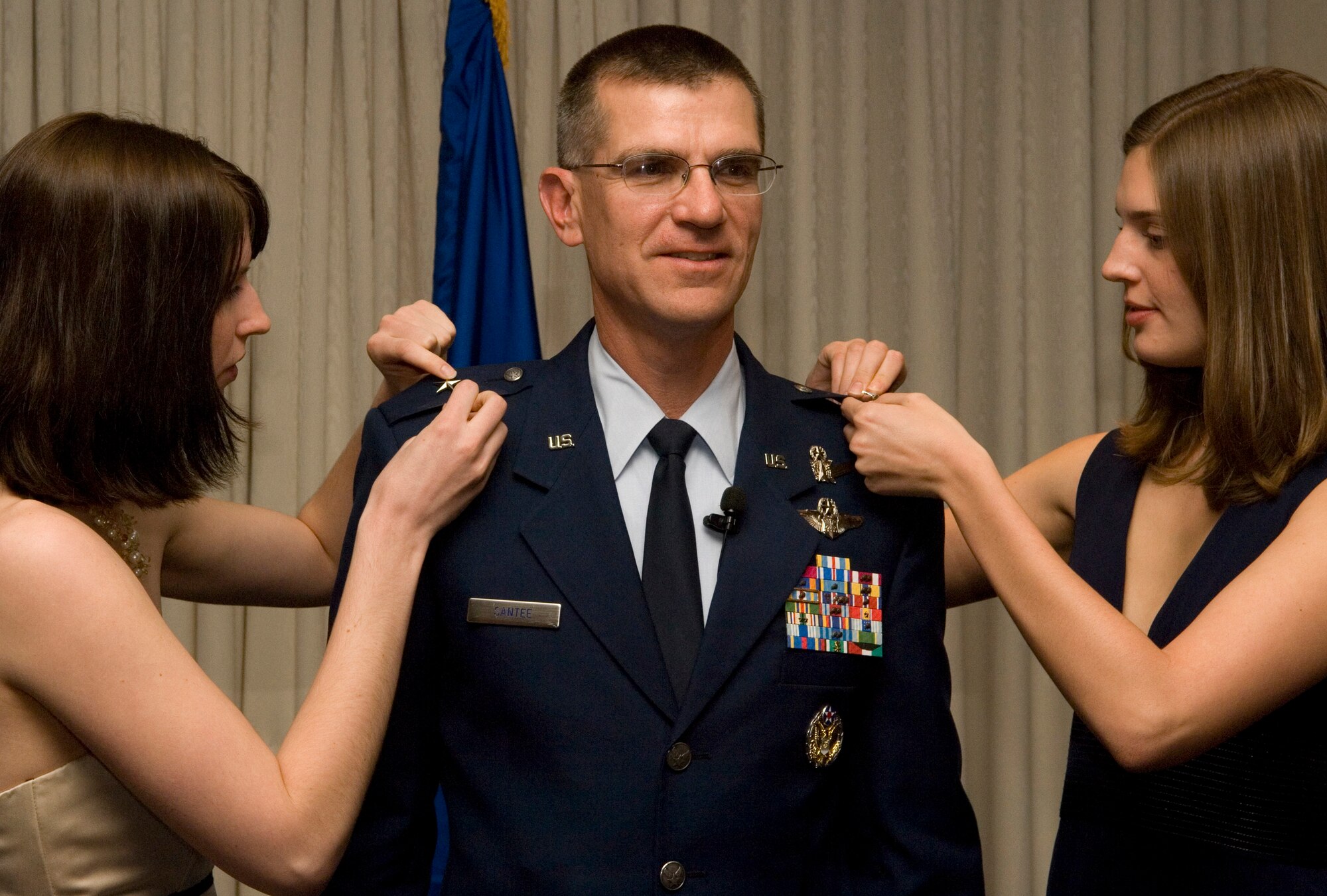 VANDENBERG AIR FORCE BASE, Calif. -- Brig. Gen. Jay Santee's daughters, Rachel and Emily, pin on new rank during his promotion ceremony on Nov. 24. Gen. Santee is the 14th Air Force vice commander and provides leadership for the 14th AF staff, five space wings and the 614th Air and Space Operations Center. (U.S. Air Force photo/Airman 1st Class Christian Thomas)