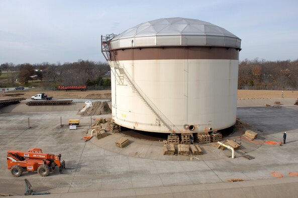 WHITEMAN Air Force Base, Mo. - Members of the 509th Civil Engineer Squadron raise a 1,260,000 gallon fuel tank in preparation for upcoming repairs to the foundation and base of the tank Nov. 30. The 509th CES will move the tank 130 feet using locomotive wheels and railroad tracks Dec. 4. (U.S. Air Force photo/Staff Sgt Charles D. Larkin Sr.)