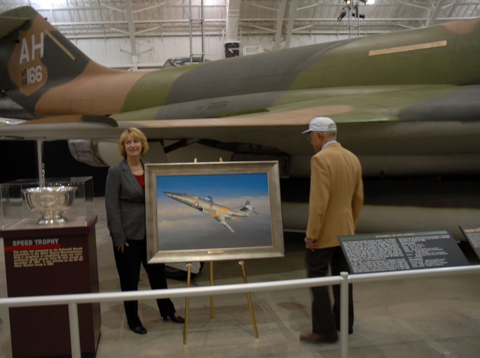 Cindy Miller (left), daughter of Col. Ray Schrecengost, the pilot of the RF-101C "CIN MIN," and retired Lt. Col. Robert Burkhart, a pilot during Operation Sun Run, stand near the RF-101C "CIN MIN" in the Modern Flight Gallery at the National Museum of the U.S. Air Force at Dayton, Ohio, Nov. 27. (U.S. Air Force photo) 