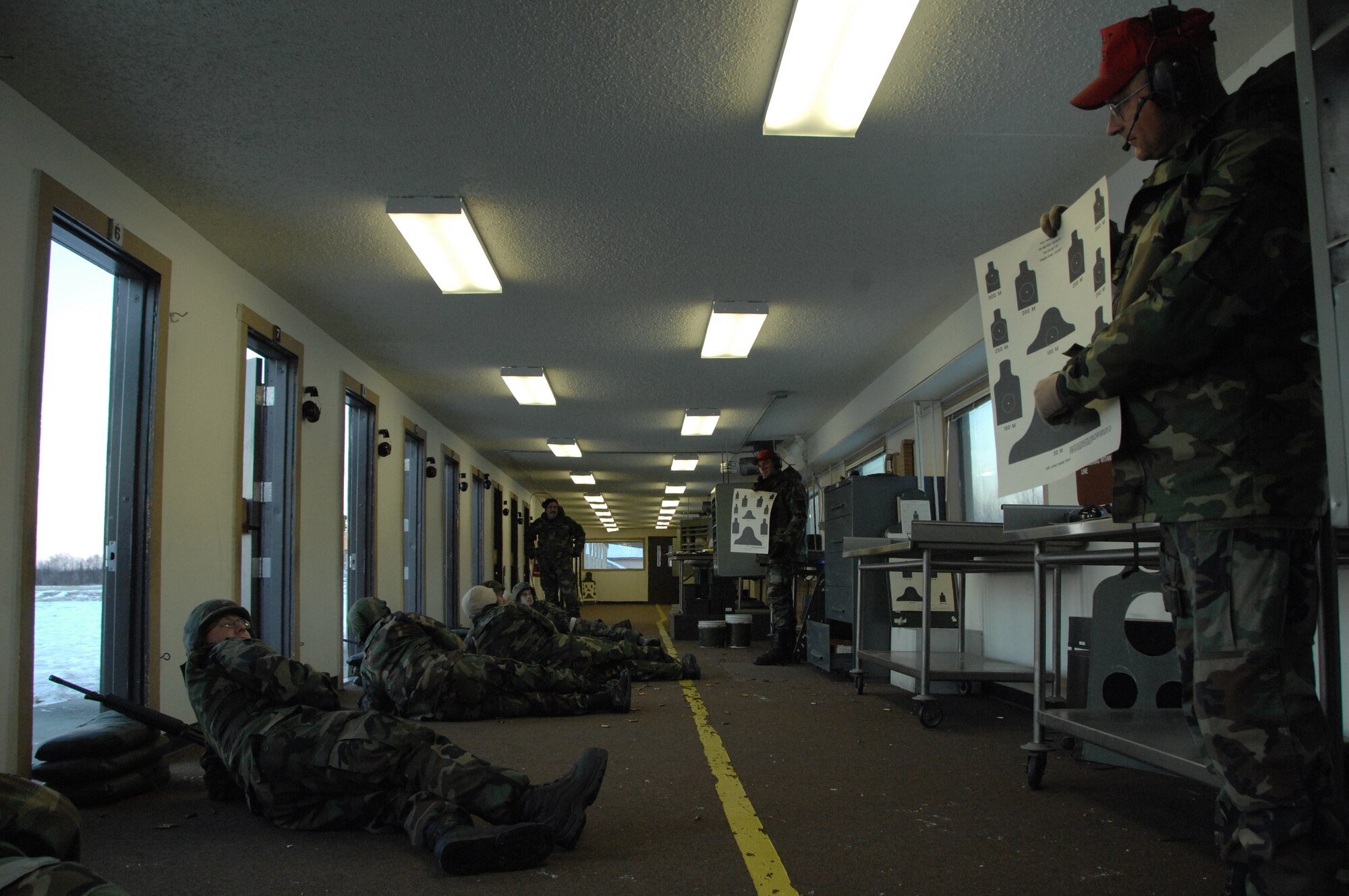 EIELSON AIR FORCE BASE, Alaska -- Tech. Sgt. Daniel Coon, 354th Security Force, NCO in charge of combat arms, explains the order in which the targets should be fired at when trying to qualify with the M16 Nov. 29, 2007. Shooting at Eielson gives more opportunities to train with different weapons because of the impact range, such weapons include M16A2, M4, M9, M11, M24, M870, M249, M203, AT4, and the MK19 automatic grenade launcher. (U.S. Air Force photo by Airman 1st Class Christopher Griffin)