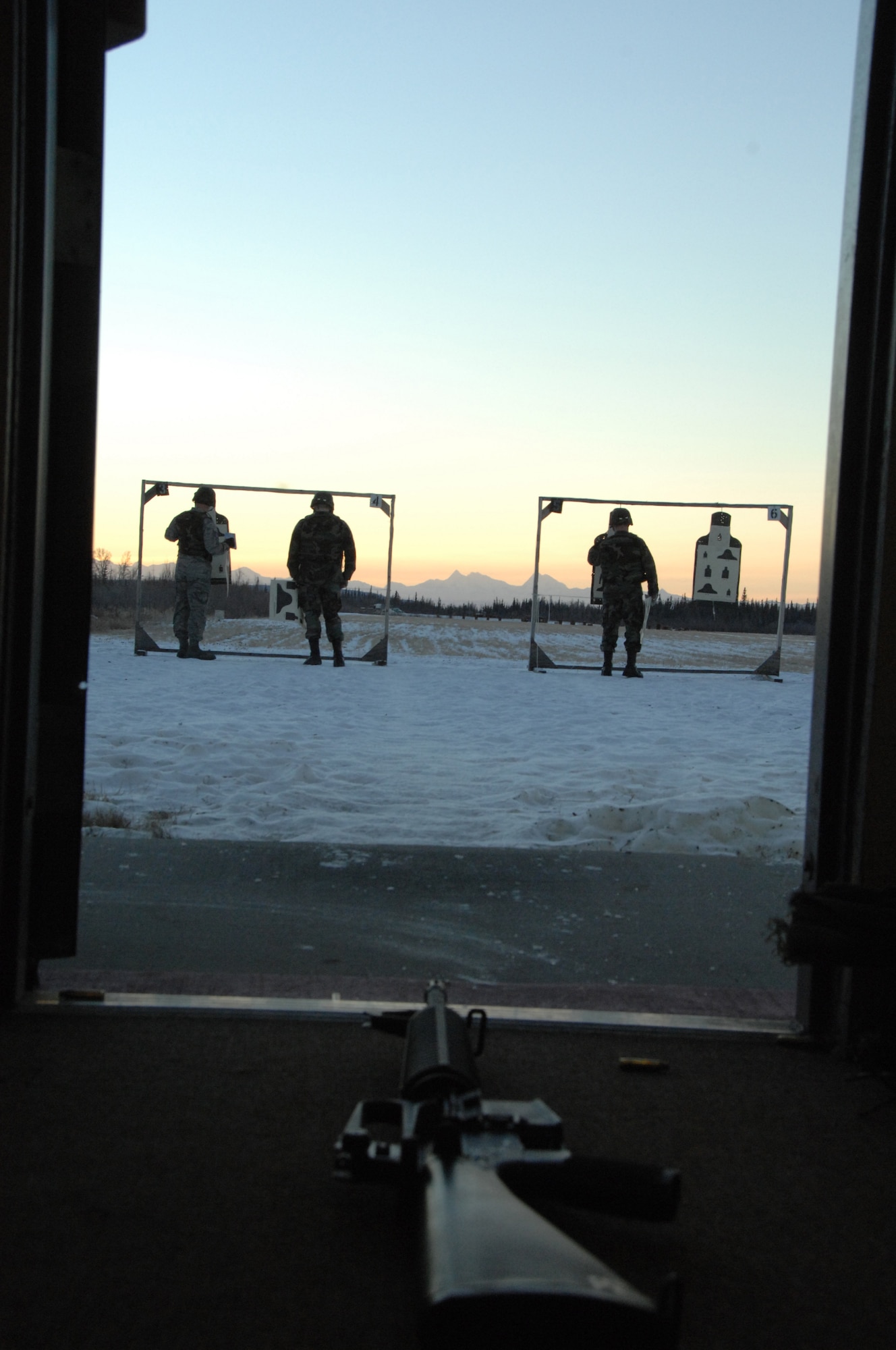 EIELSON AIR FORCE BASE, Alaska -- Airmen of the 354th Fighter wing check their targets down range Nov. 29, 2007 at the small arms range. Eielson's small arms range trains roughly more than 1,900 people with the M16 and M4 rifles and M9 pistol per year, the range is still capable of qualifying Airmen for firearms in arctic temperatures, going as low as negative 40 degrees.  (U.S. Air Force photo by Airman 1st Class Christopher Griffin)