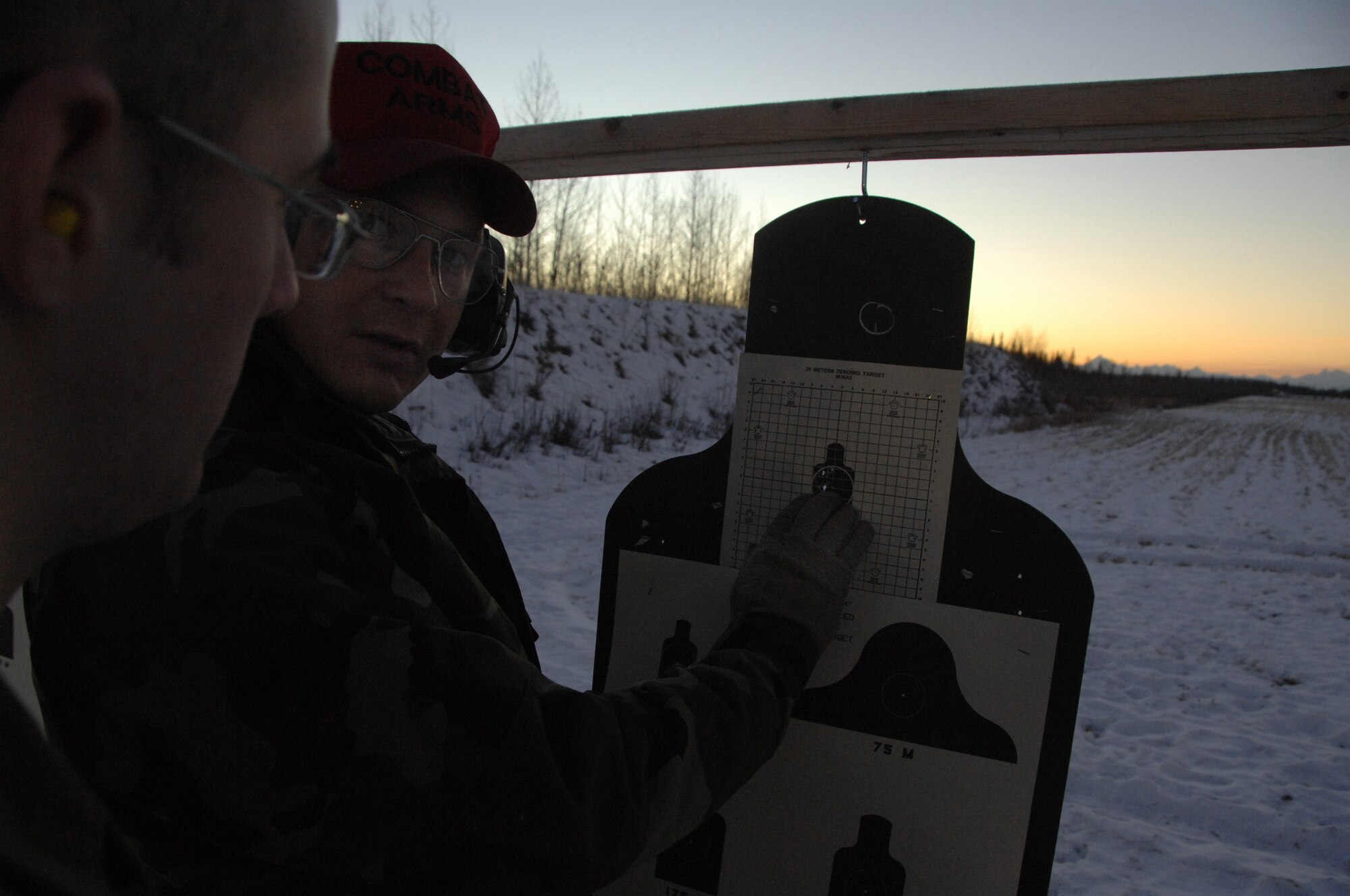 EIELSON AIR FORCE BASE, Alaska -- Tech. Sgt. Daniel Coon, 354th Security Force, NCO in charge of combat arms, gives advice to Senior Airman Joseph Costa, 354th Communications Squadron tactical network administrator, on what adjustments should be made to improve accuracy when firing the M16 Nov. 29, 2007. Shooting at Eielson gives more opportunities to train with different weapons because of the impact range, such weapons include M16A2, M4, M9, M11, M24, M870, M249, M203, AT4, and the MK19 automatic grenade launcher.  (U.S. Air Force photo by Airman 1st Class Christopher Griffin)