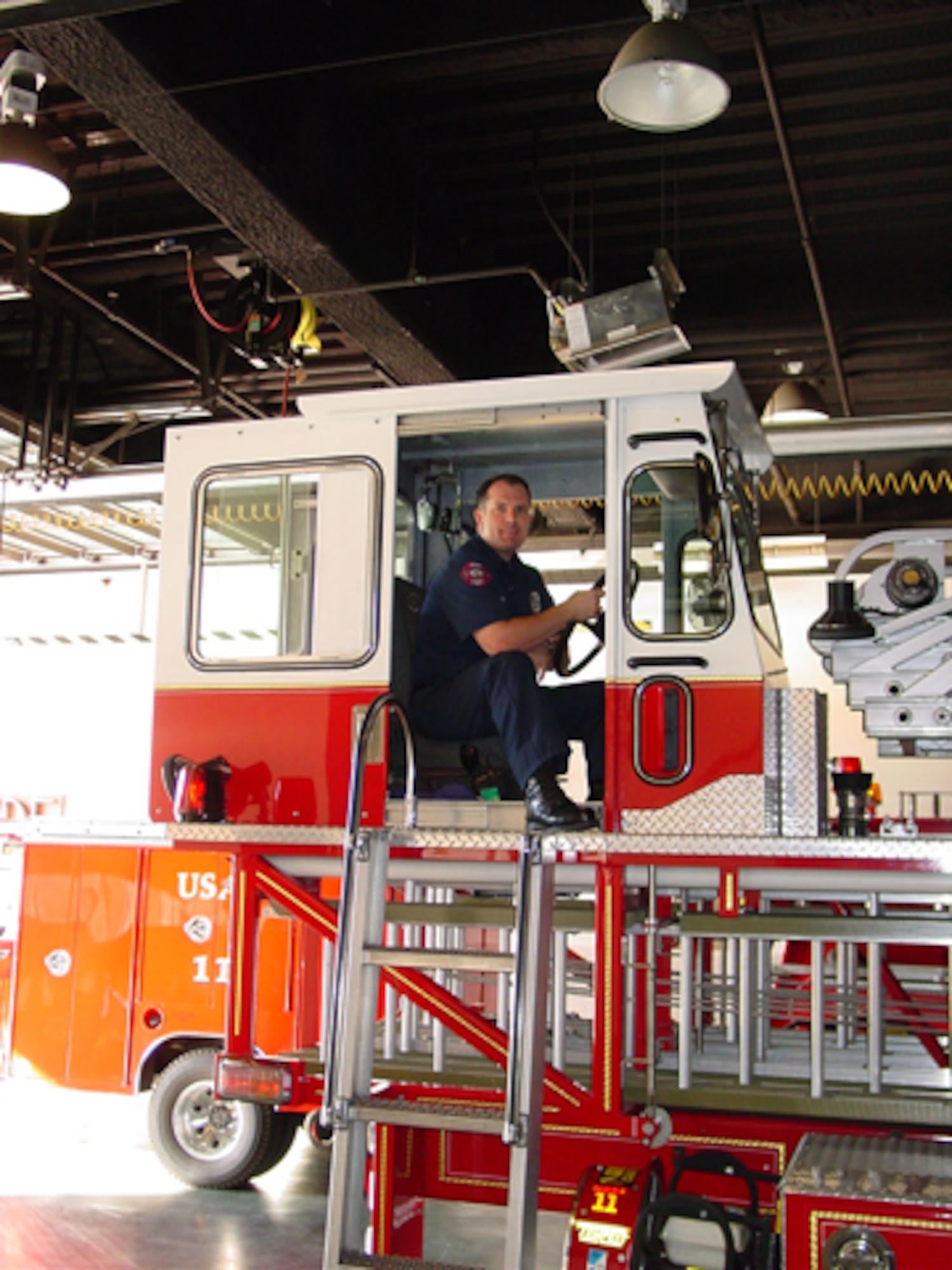 Burbank firefighter and Air Force Reserve Capt. Ken Hultgren sits up in the Tillerman's Position on the Aerial Ladder Truck.  Captain Hultgren calls it “the best spot on the job.  I get to drive the back of the truck.”