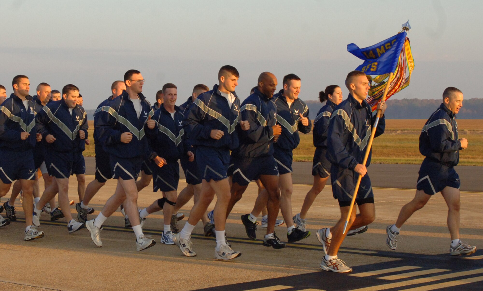Members of the 14th Secuirty Forces Squadron run in formation during the Warrior Run with their commander, Maj. Kiley Stinson, leading the way. (U.S. Air Force photo by Airman 1st Class Danielle Powell)