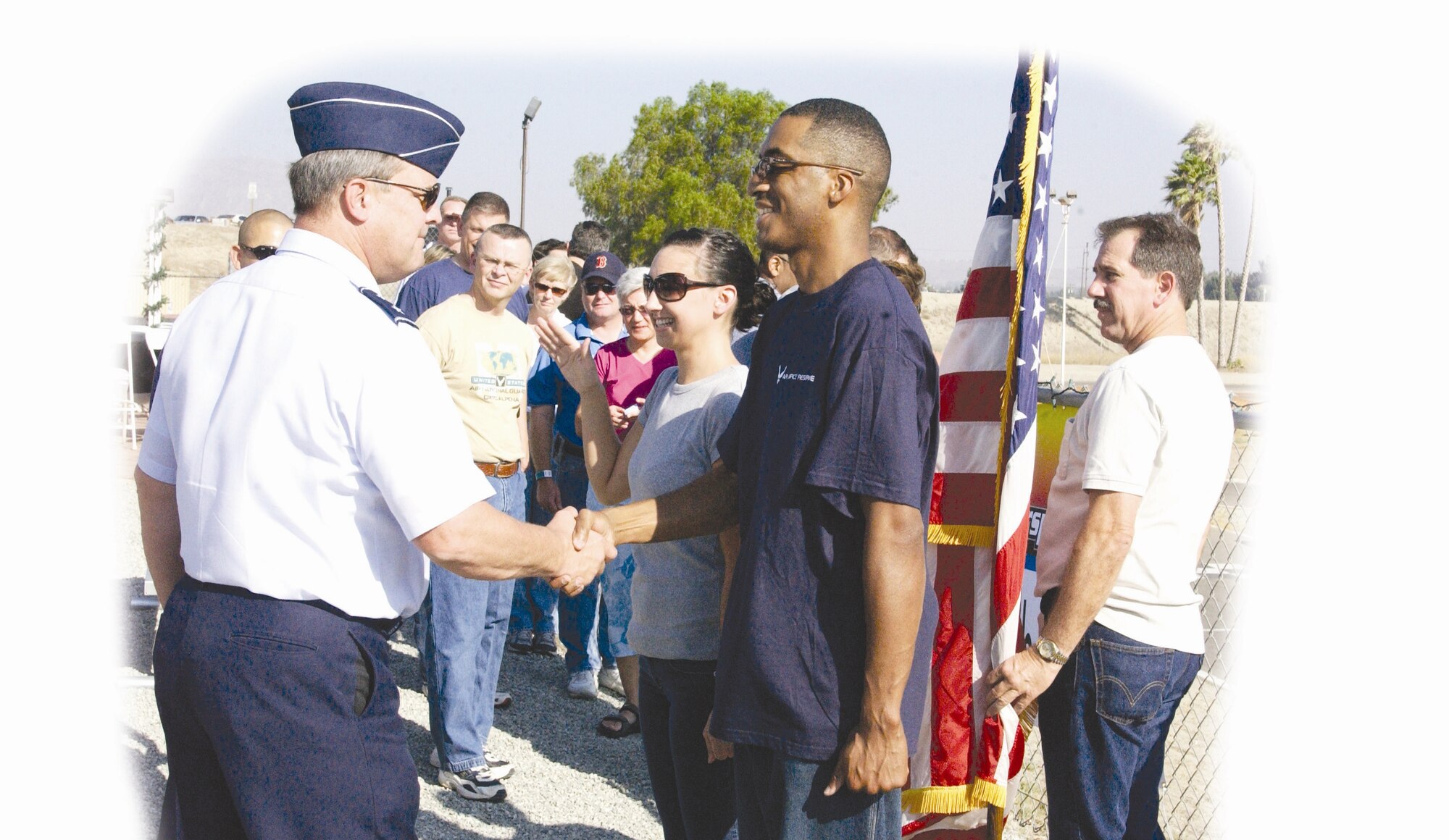 Maj. Gen. Robert Duignan, 4th Air Force Commander, shakes hands with two new Airmen after swearing them into the Air Force Reserve in June. (U.S. Air Force photo by Amy Abbott/452 AMW/PA)