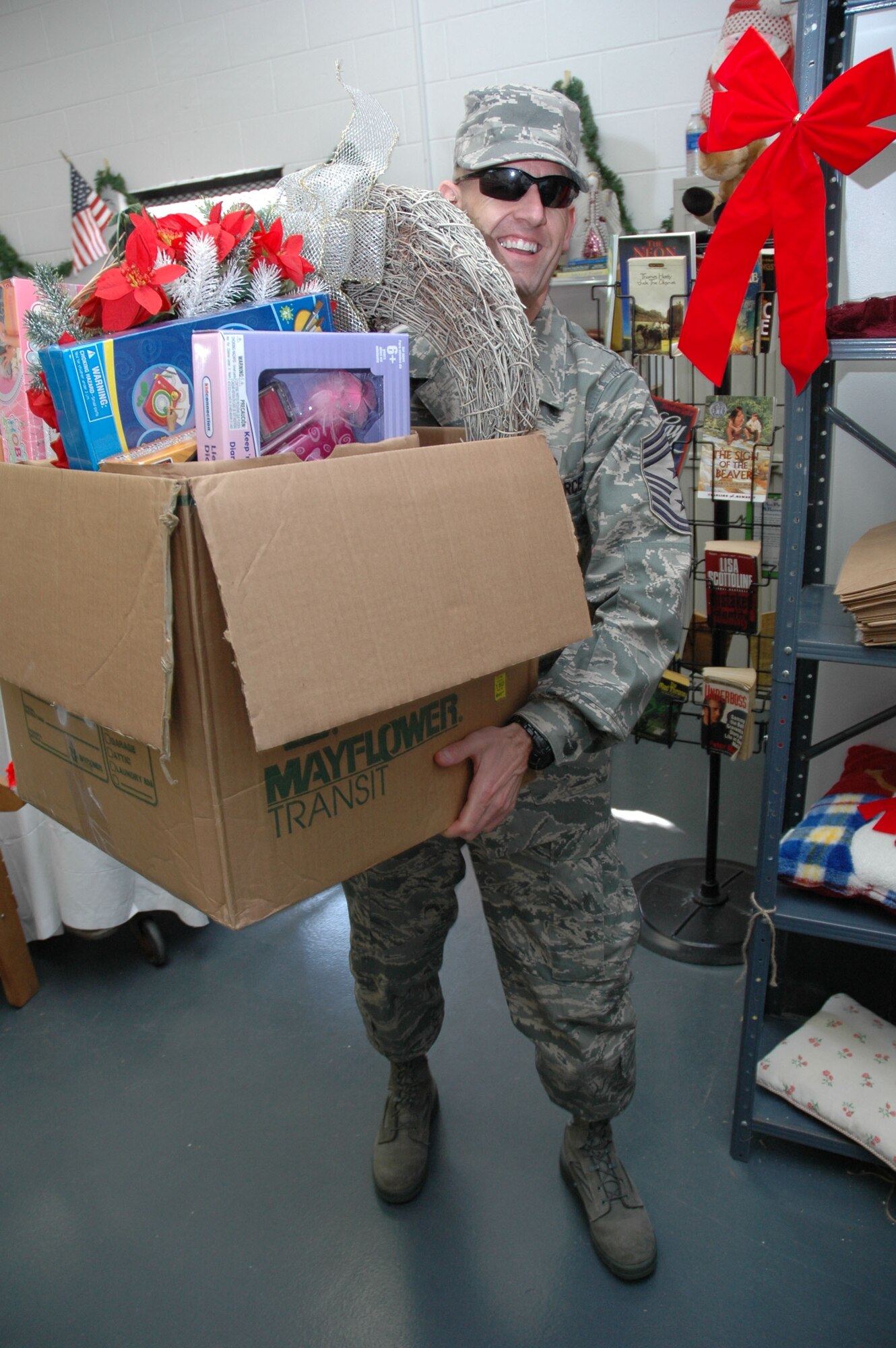 EGLIN AIR FORCE BASE, Fla. -- Chief Master Sgt. Troy Engholm, 96th Air Base Wing command chief master sergeant, carries a box of toys out to a car for an Airman during the Toys-for-Tots distribution at the Airman?s Attic Nov. 29. During the event, parents selected 1,495 toys to be given to 299 children this Christmas. Another distribution is scheduled for the middle of December at the Airman?s Attic. Overall, they anticipate giving more than 4,000 toys to 600 children this holiday season. (U.S. Air Force photo by Staff Sgt. Mike Meares)