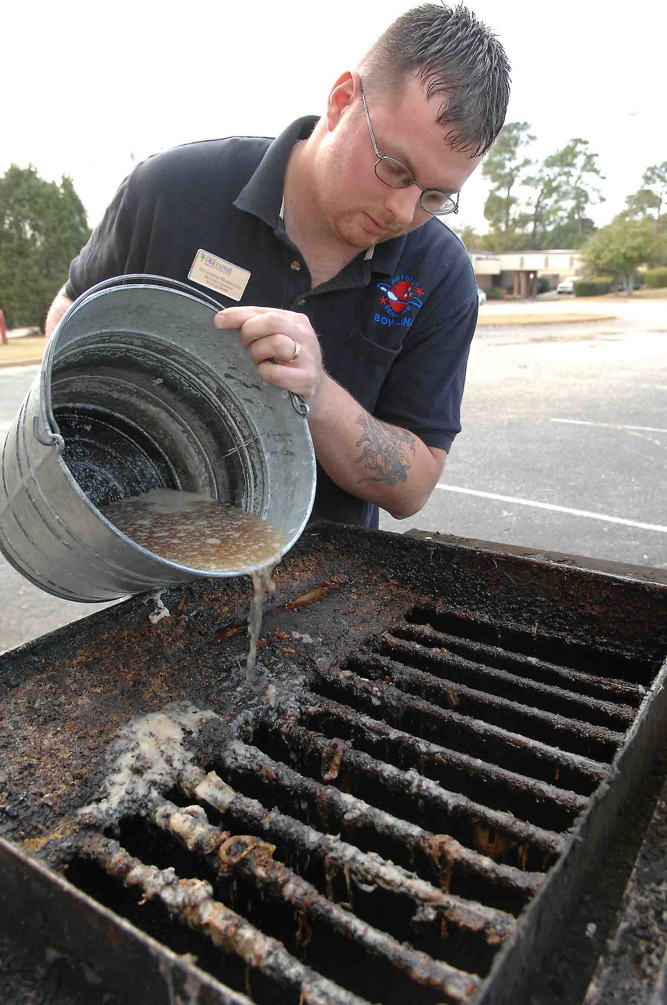 SHAW AIR FORCE BASE, S.C. -- Chris Rosebrooks, Shaw bowling alley recreation assistant, pours grease into the vat for proper disposal. Shaw members are encouraged to dispose of their used cooking oil in the vat located at the Shaw Bowling Center. (U.S. Air Force photo/Staff Sgt. Josef Cole)