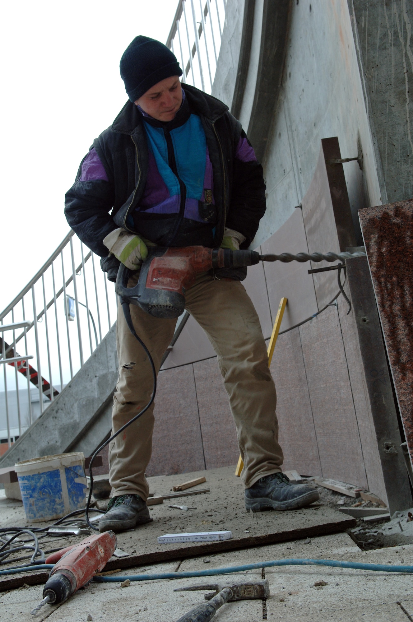 Bober Yozet, Bamberger construction contractor, prepares a wall for mounting stone sectioning on the Kaiserslautern Military Community Center on Ramstein Air Base, Germany.  While the project has taken longer than originally scheduled, both US and German representatives at all levels remain committed to finishing it. (U.S. Air Force photo/Airman 1st Class Marc I. Lane)