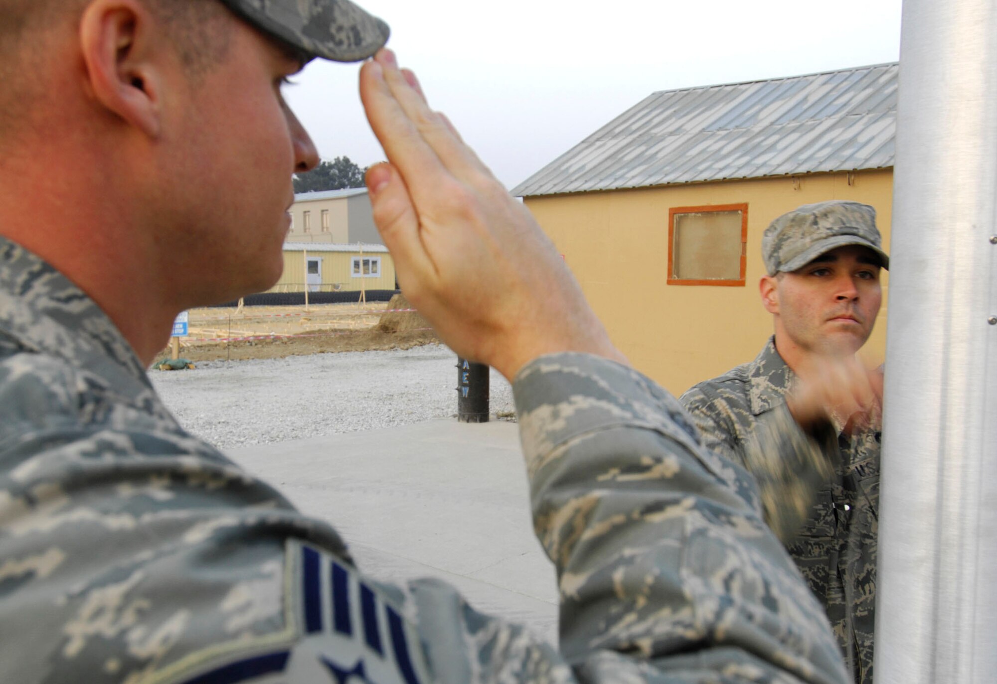 BAGRAM AIR BASE, Afghanistan - Staff Sgt. Jeremiah Hall (left) and Staff Sgt. Michael DeJesus, both members of the 455th Expeditionary Security Forces Squadron, raise the Afghan flag on a newly installed flagpole here, Nov. 30, 2007.
(U.S. Air Force photo/Staff Sgt. Joshua T Jasper)  (Released)