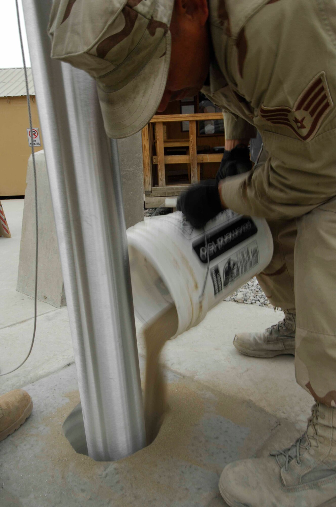 BAGRAM AIR BASE, Afghanistan - A member of the 455th Expeditionary Civil Engineering Squadron helps install two new flagpoles on Camp Cunningham here, Nov. 29, 2007.  (U.S. Air Force photo/Staff Sgt. Joshua T Jasper)  (Released)