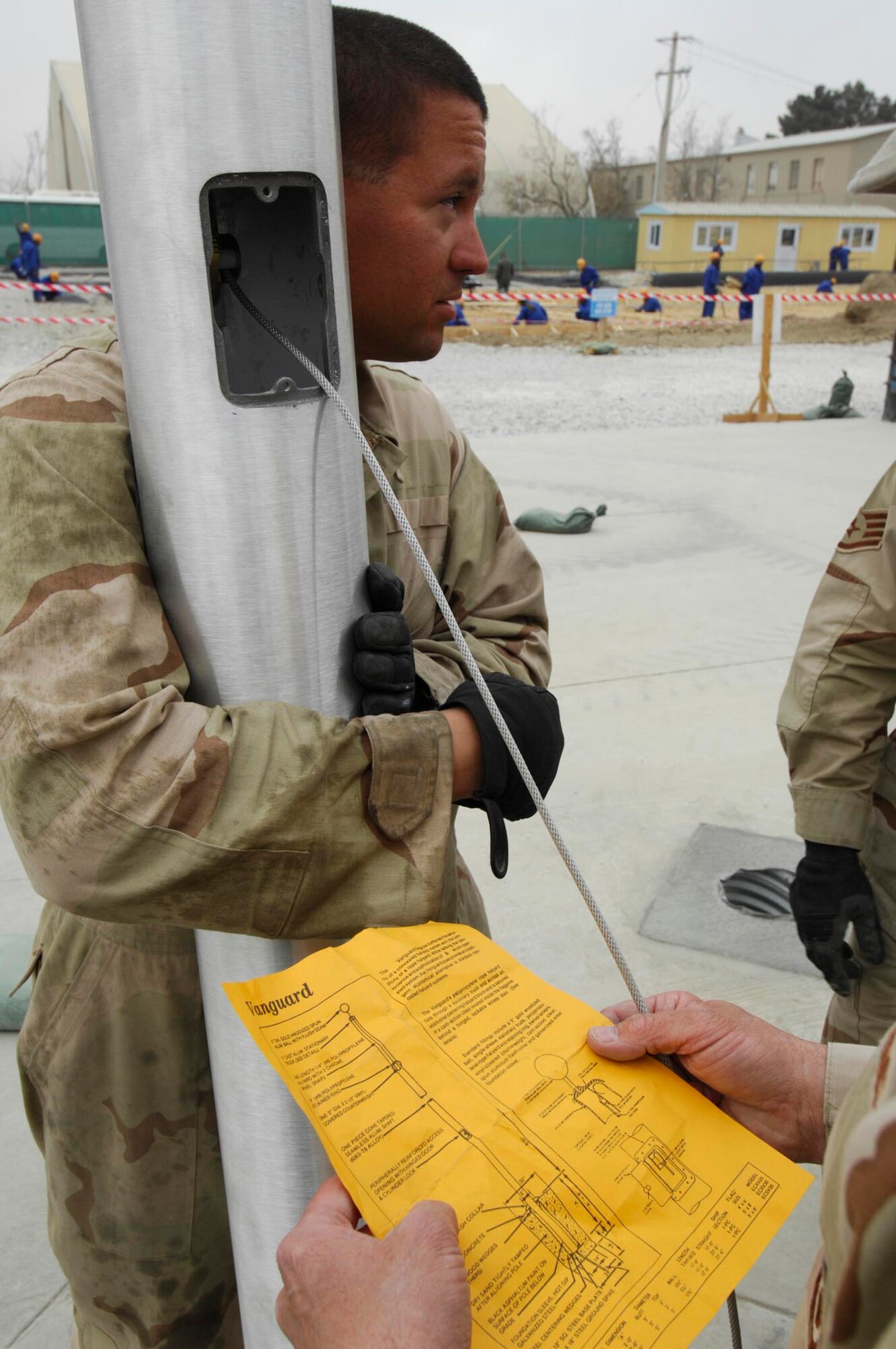 BAGRAM AIR BASE, Afghanistan - Members of the 455th Expeditionary Civil Engineering Squadron help install two new flagpoles on Camp Cunningham here, Nov. 29, 2007.  (U.S. Air Force photo/Staff Sgt. Joshua T Jasper)  (Released)