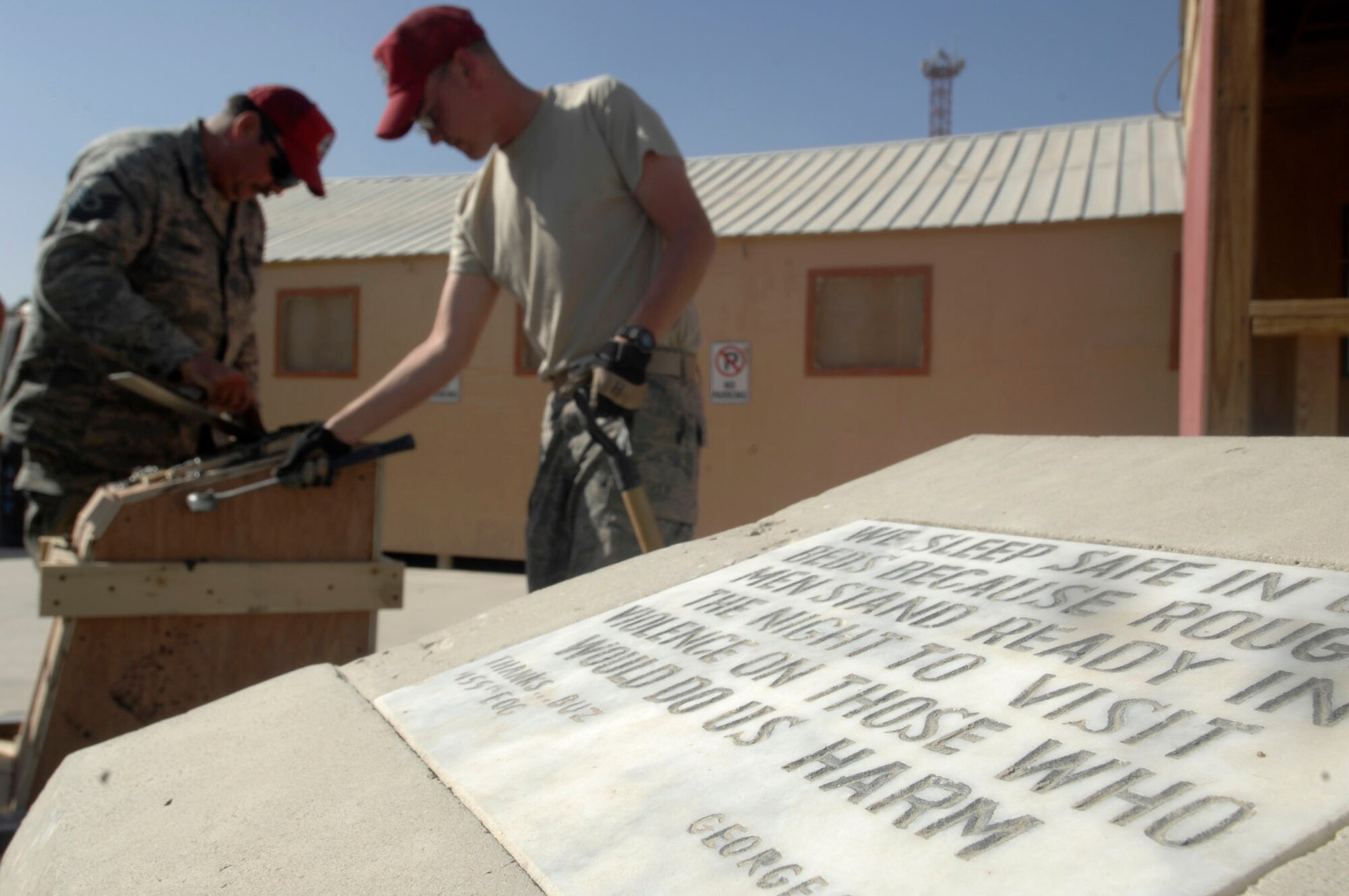 BAGRAM AIR BASE, Afghanistan - Members of the 1st Expeditionary Red Horse Squadron smooth concrete just poured in a form that will soon be a new column near the center Camp Cunningham here, Nov. 1, 2007.  Camp Cunningham is named after Senior Airman Jason Cunningham, a pararescueman killed in action while saving the lives of 10 other service members on March 4, 2004.