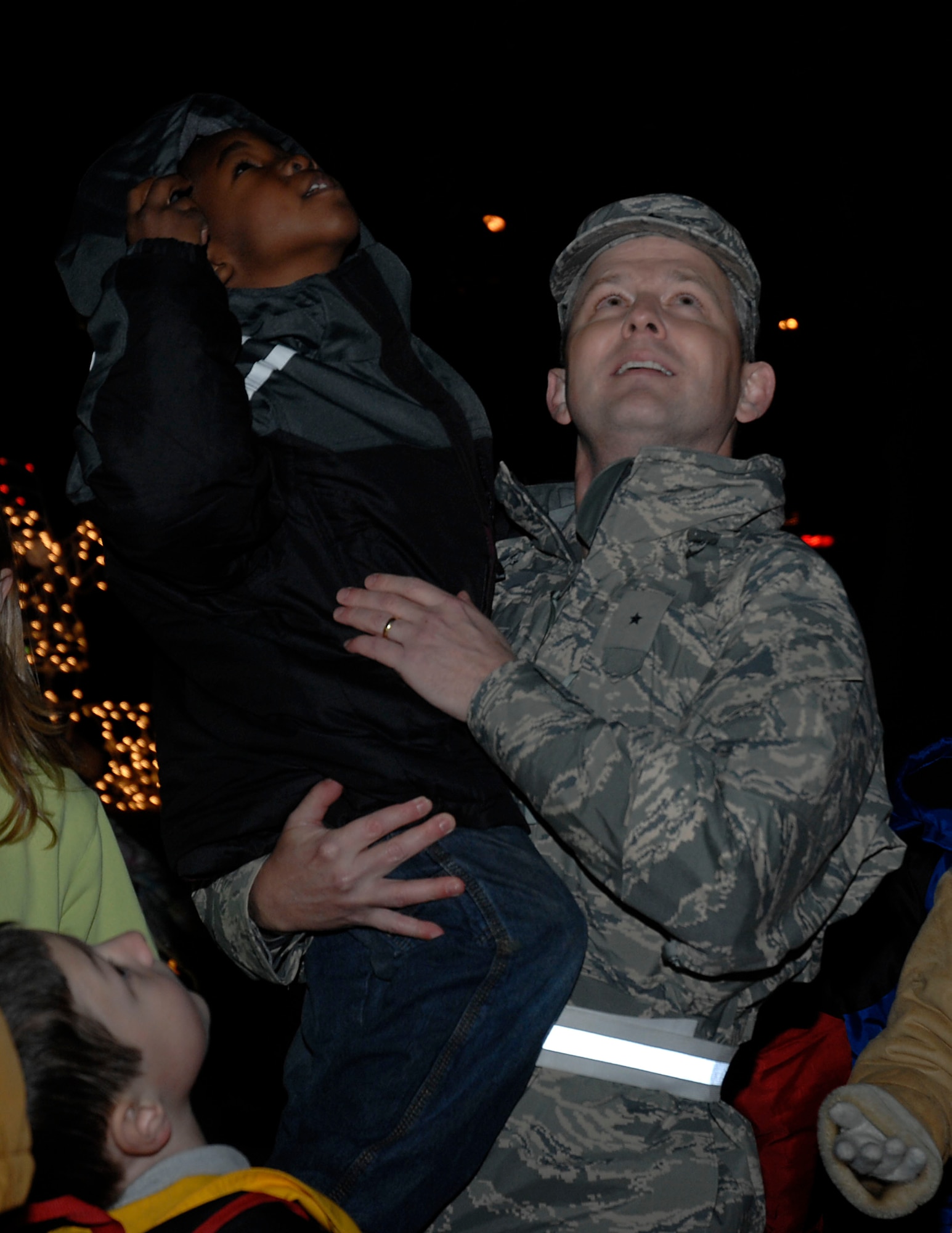 Brig. Gen. John Hesterman, 48th Fighter Wing commander, and Antwan Hopkins, son of Capt. Antwan Hopkins, 100th Comptroller Squadron, look upon lights decorating a tree used during the annual Christmas Tree Lighting Ceremony held at RAF Lakenheath, Nov. 29. Antwan Hopkins was the child chosen to push the lever turning on the lights signifying the start of the Christmas season. (U. S. Air Force photo by Senior Airman Brian J. Ellis)