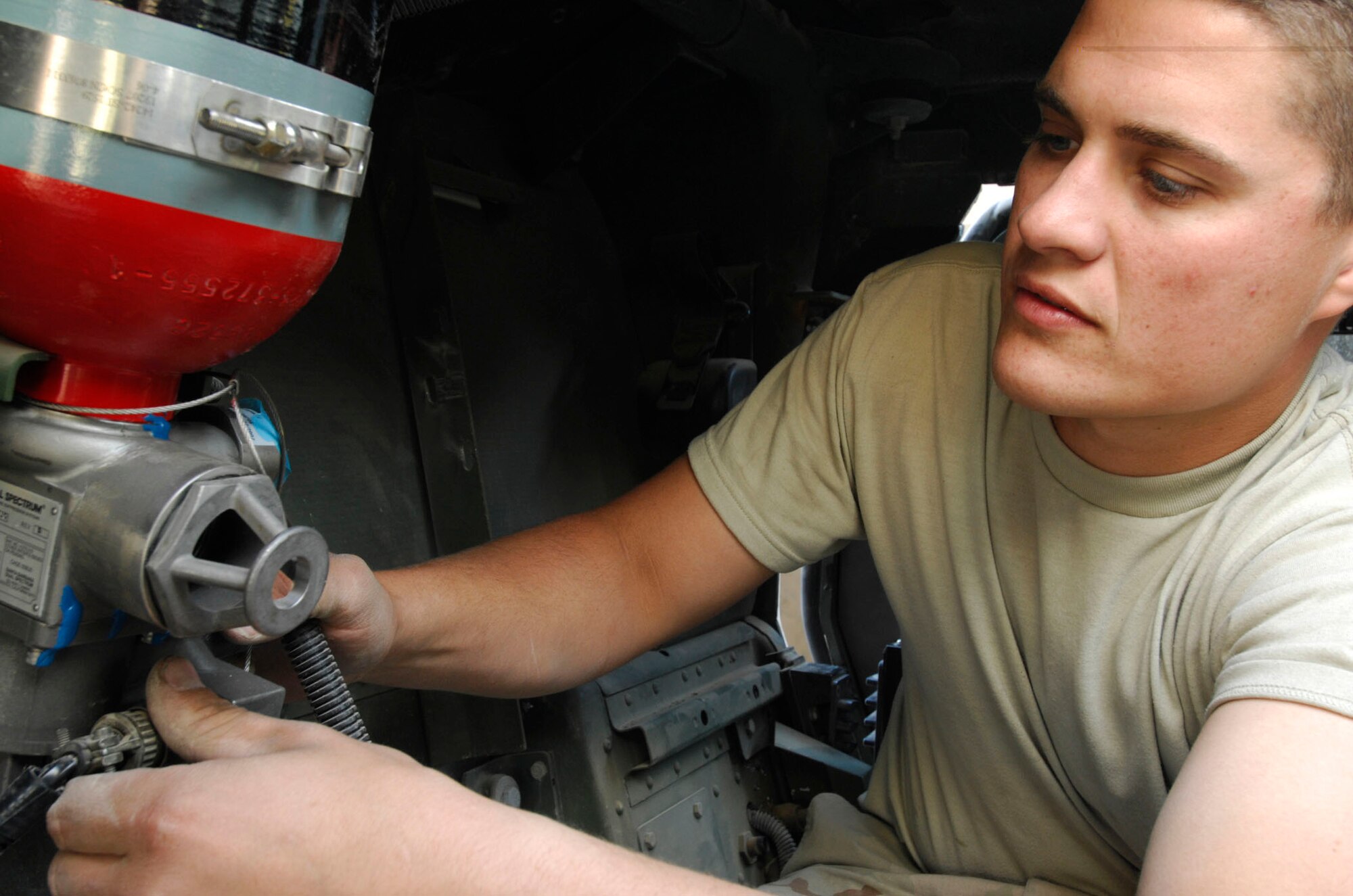BAGRAM AIR BASE, Afghanistan - Senior Airman Josh Theunissen, a member of Frag Team 5, installs components of  a fire suppression system inside of a High Mobility Multipurpose Wheeled Vehicle, Nov 27, 2007.  Frag Team 5 is responsible for installing up-armor kits, fire suppression systems, improved seat belts, and gunner restraints in Air Force combat vehicles.
(U.S. Air Force photo/Staff Sgt. Joshua T Jasper)  (Released)