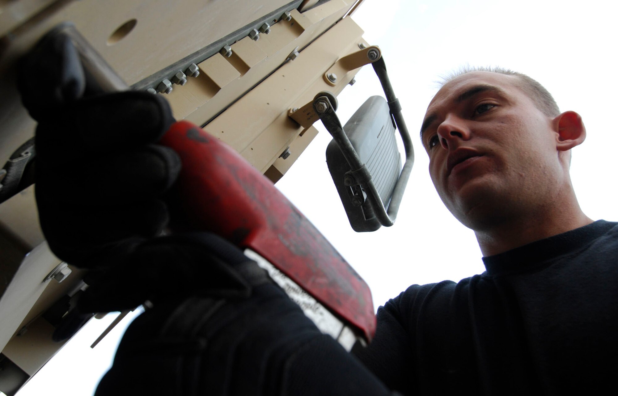 BAGRAM AIR BASE, Afghanistan -  Staff Sgt. Benjamin Johnson, a Frag Team 5 member, secures plates of armor to a High Mobility Multipurpose Wheeled Vehicle, Nov 27, 2007.   Frag Team 5 is responsible for installing up-armor kits, fire suppression systems, improved seat belts, and gunner restraints in Air Force combat vehicles.
(U.S. Air Force photo/Staff Sgt. Joshua T Jasper)  (Released)
