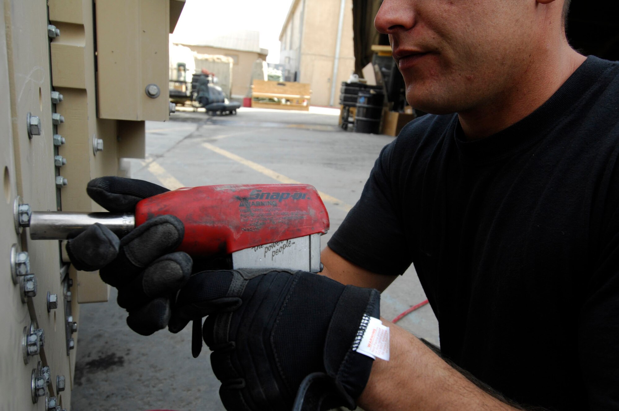 BAGRAM AIR BASE, Afghanistan -  Staff Sgt. Benjamin Johnson, a Frag Team 5 member, secures plates of armor to a High Mobility Multipurpose Wheeled Vehicle, Nov 27, 2007.   Frag Team 5 is responsible for installing up-armor kits, fire suppression systems, improved seat belts, and gunner restraints in Air Force combat vehicles.
(U.S. Air Force photo/Staff Sgt. Joshua T Jasper)  (Released)
