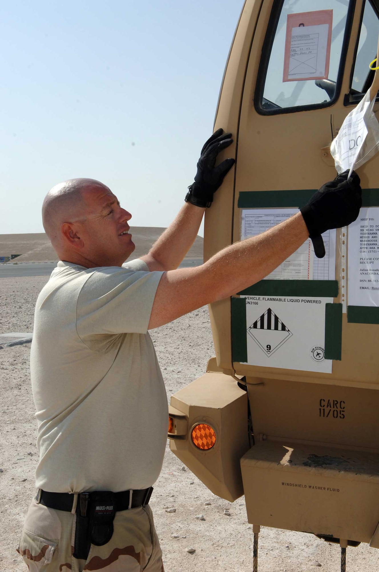 SOUTHWEST ASIA - Staff Sgt. Brian Grimm, 8th Expeditionary Air Mobility Squadron, checks the transportations control number of a vehicle being shipped to Dover AFB, Del., at a base in Southwest Asia. Sergeant Grimm is deployed from the 139th Airlift Wing in Saint Joseph's Mo. His hometown is Lees Summit, Mo. (U.S. Air  Force photo/Master Sgt. Greg Kunkle)