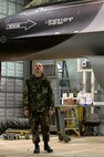 KUNSAN AIR BASE, South Korea --  Tech. Sgt. Brian Coffel looks over a newly painted arctic scheme F-16 aircraft here Nov 30.  Sergeant Coffel and members of the 8th Maintenance Squadron painted the aircraft in preparation for an upcoming Eielson/Kunsan F-16 swap.  The aircraft is the first F-16 to have an arctic scheme.  (U.S. Air Force photo/ Tech. Sgt. Quinton T. Burris)