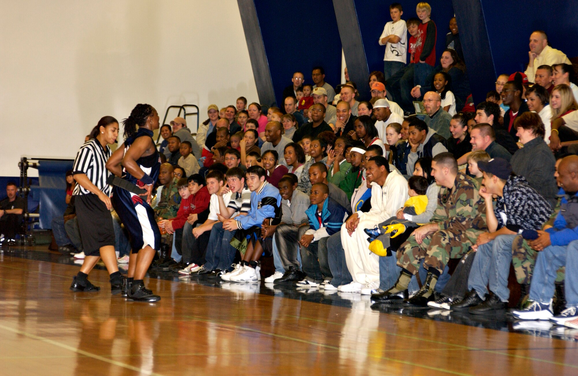 MISAWA AIR BASE, Japan -- Kerrie James, a referee from the Harlem Ambassadors, calls a foul on Lade Majic for tackling a player from the Misawa Jets at the Potter Fitness Center on Nov. 28, 2007. Lade Majic is the captain for the Ambassadors and has been part of the show basketball team since it started in 1998. (US Air Force photo by Airman 1st Class Eric Harris)