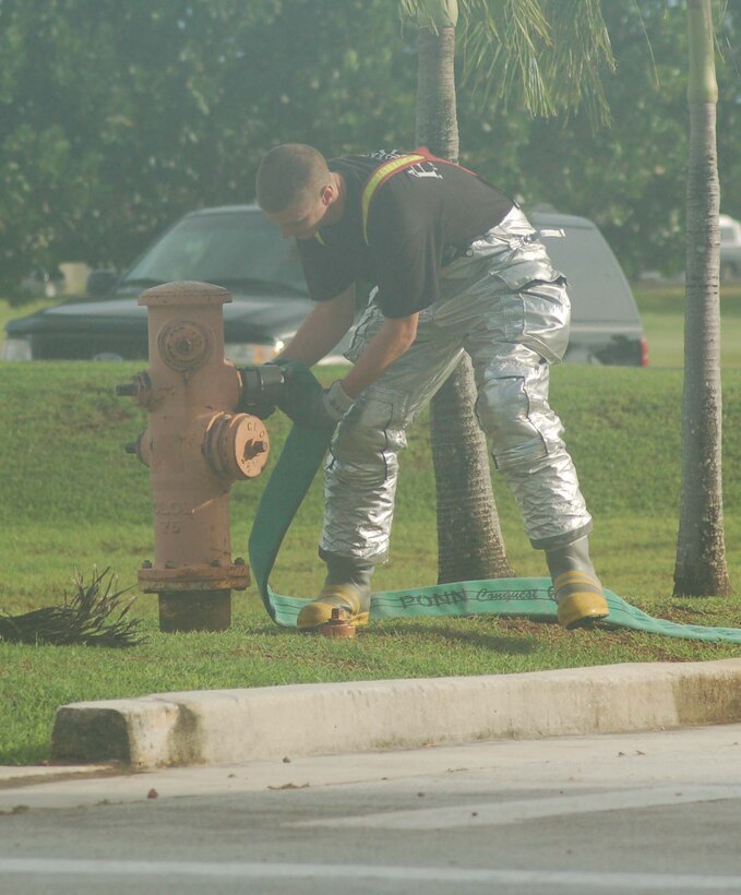 Airman 1st Class Joshua Mackie, 36th Civil Engineer Squadron, rapidly connects a 3-inch supply line to a hydrant. Andersen's fire department is preparing for the Fire Muster Competition scheduled for Oct. 6 and 7. All on-island fire departments, including Guam, Navy and Andersen, will participate. (U.S. Air Force photo/Senior Airman Angelique Smythe)