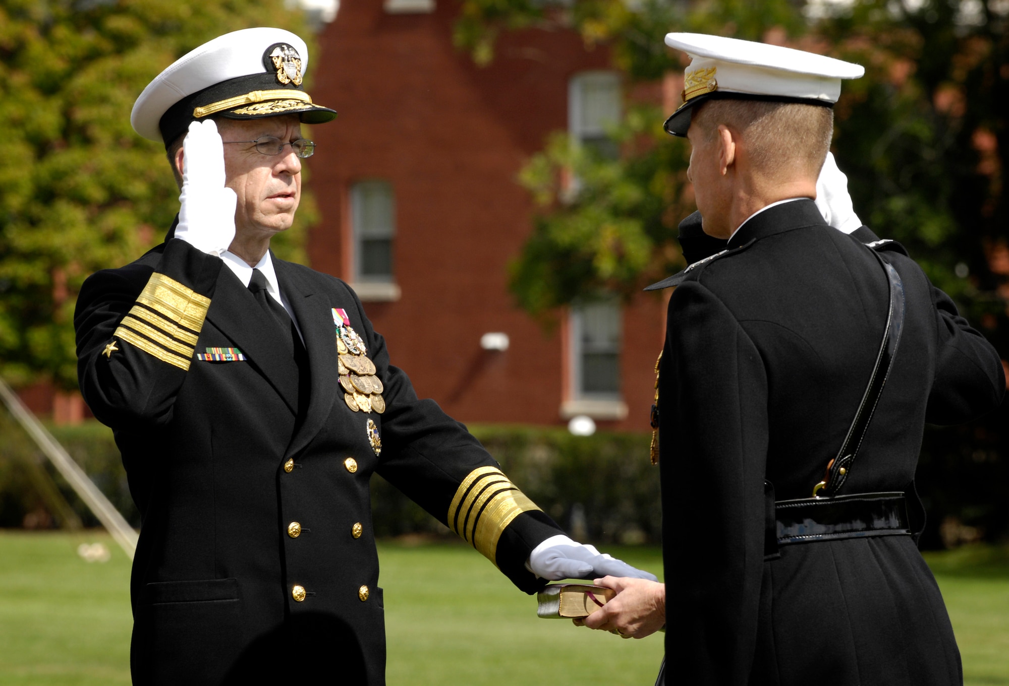 Navy Adm. Michael G. Mullen is sworn in as the 17th chairman of the Joint Chiefs of Staff and takes the oath of office from Marine Gen. Peter Pace during an Armed Forces Hail and Farewell ceremony at Ft. Myer, Va., Oct. 1. (Defense Department photo/Cherie A. Thurlby)