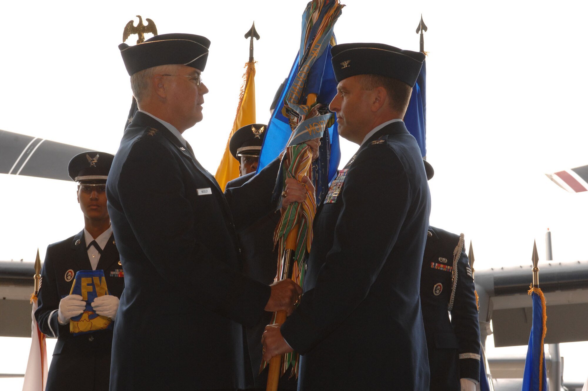Lt. Gen. Michael W. Wooley (left), commander of Air Force Special Operations Command, passes the guidon of the newly formed 27th Special Operations Wing to the new commander of the wing Col. Tim Leahy. (U.S. Air Force photo by Airman 1st Class Evelyn Chavez)