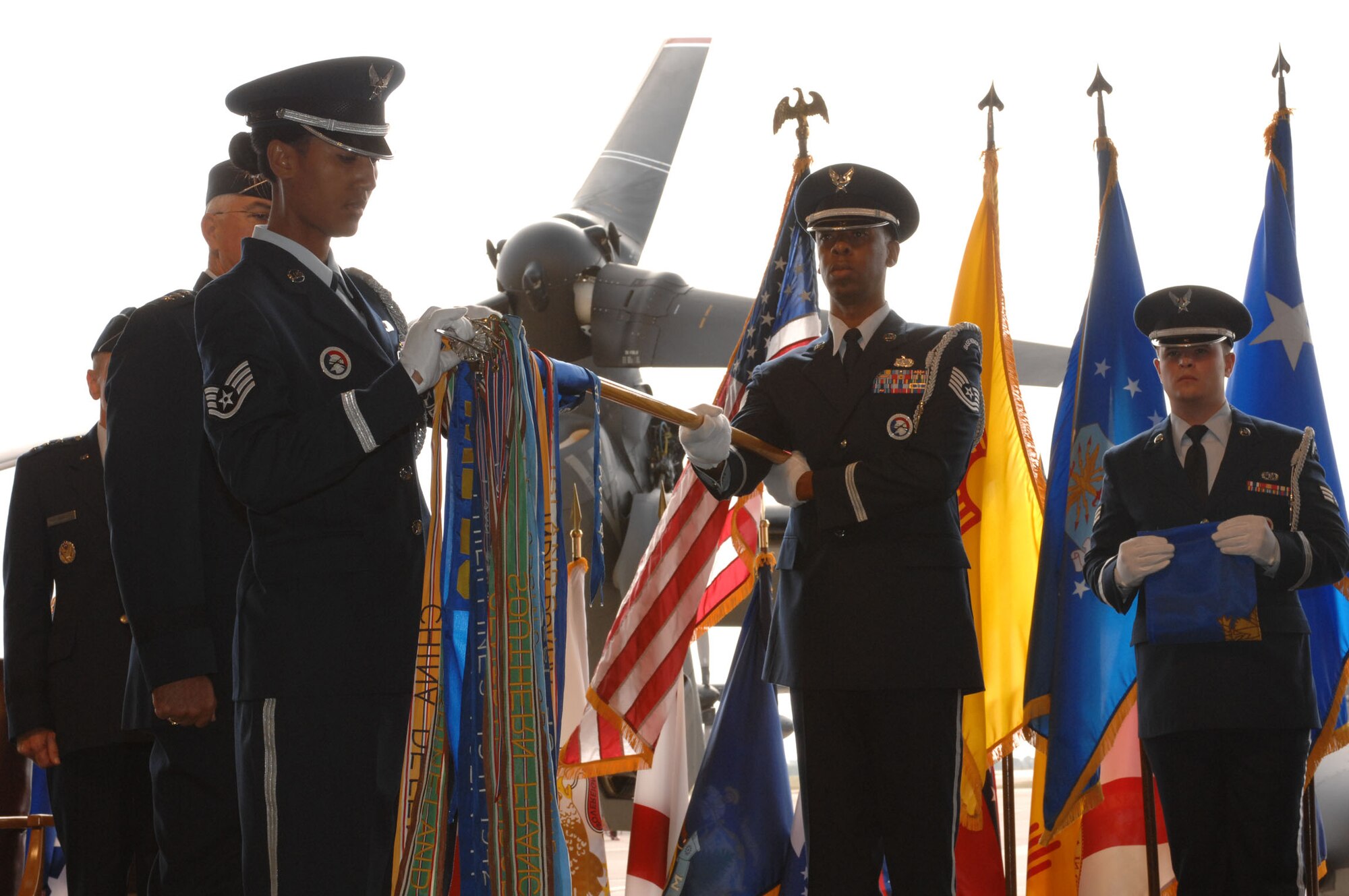 CANNON AIR FORCE BASE, N.M. -- Staff Sgt. Torrie McCutcheon, of the Cannon Honor Guard, removes the 27th Fighter Wing flag from the guidon held by Tech. Sgt. Rodney Barner, also of the Honor Guard. The flag was replaced by the 27th Special Operations Wing flag during a change-of-command ceremony at Cannon Air Force Base Oct. 1. (U.S. Air Force photo by Airman 1st Class Evelyn Chavez)