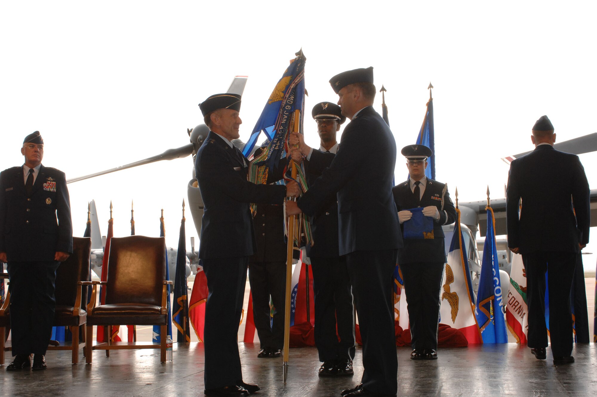 CANNON AIR FORCE BASE, N.M. -- Lt. Gen. Norman R. Seip, 12th Air Force commander, (left) accepts the guidon from Col. Scott West, former commander of the 27th Fighter Wing, (right) who relinquished command of the 27th Fighter Wing in a change-of-command ceremony Oct. 1. The ceremony inactivated the 27th Fighter Wing and was redesignated the 27th Special Operations Wing. (U.S. Air Force photo by Airman 1st Class Evelyn Chavez)