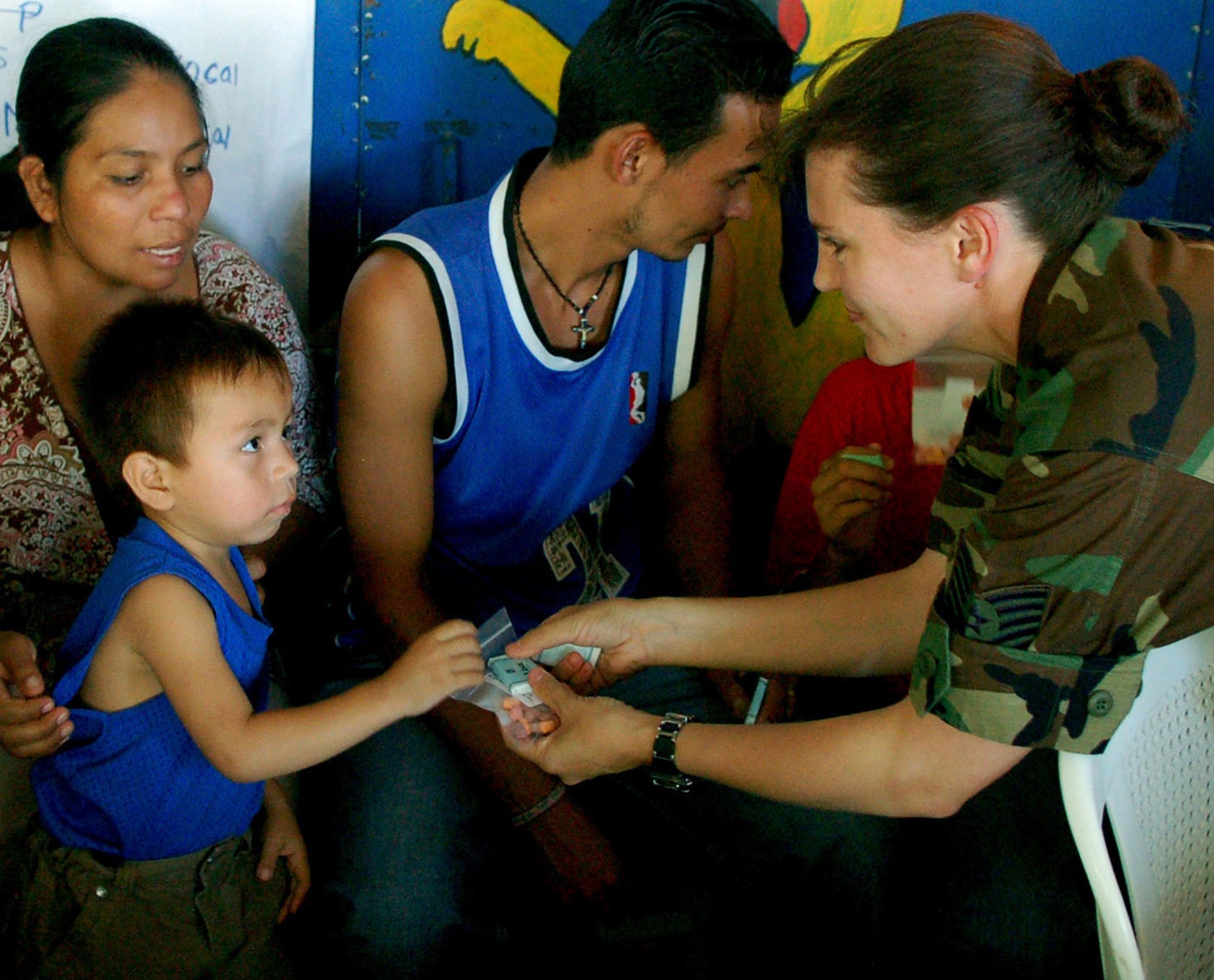 Tech. Sgt. Angel Roush hands a bag of vitamins to a young Salvadorian boy Sept. 27 at a makeshift clinic in San Juan Opico, El Salvador, during a medical readiness training exercise. Sergeant Roush is a member of the Joint Task Force-Bravo Medical Element. JTF-Bravo members participated with the Salvadorian militaries in the exercise. (U.S. Air Force photo/Staff Sgt. Austin May) 