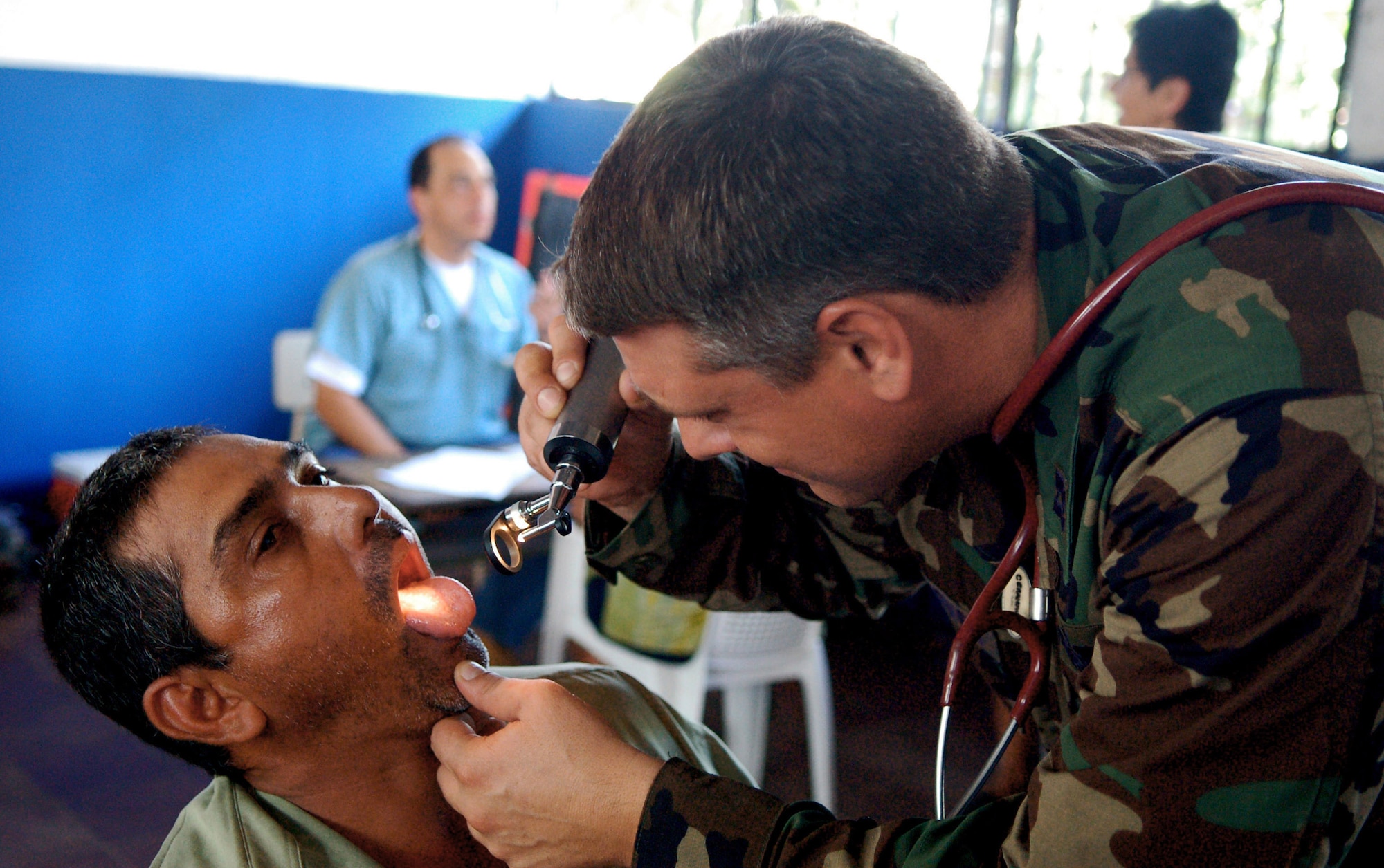 Capt. Michael Ceranowski examines a local man's throat Sept. 27 at a makeshift clinic in San Juan Opico, El Salvador, during a medical readiness training exercise. Captain Artiga is a member of the Joint Task Force-Bravo Medical Element. JTF-Bravo members participated with the Salvadorian militaries in the exercise. (U.S. Air Force photo/Staff Sgt. Austin May) 