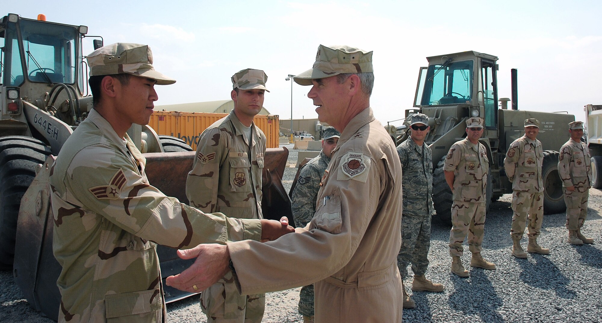 Senior Airman Khanh Le meets Maj. Gen. William L. Holland Sept. 30 in Southwest Asia. General Holland is the vice commander of 9th Air Force and the deputy commander of U.S. Central Command Air Forces. Airman Le, a 386th Expeditionary Civil Engineering Squadron pavement equipment operator, is deployed from Hickam Air Force Base, Hawaii. (U.S. Air Force photo/Staff Sgt. Tia Schroeder)
