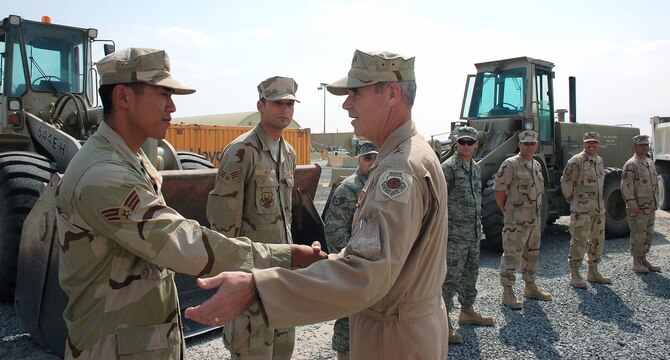 Senior Airman Khanh Le meets Maj. Gen. William L. Holland Sept. 30 in Southwest Asia. General Holland is the vice commander of 9th Air Force and the deputy commander of U.S. Central Command Air Forces. Airman Le, a 386th Expeditionary Civil Engineering Squadron pavement equipment operator, is deployed from Hickam Air Force Base, Hawaii. (U.S. Air Force photo/Staff Sgt. Tia Schroeder)
