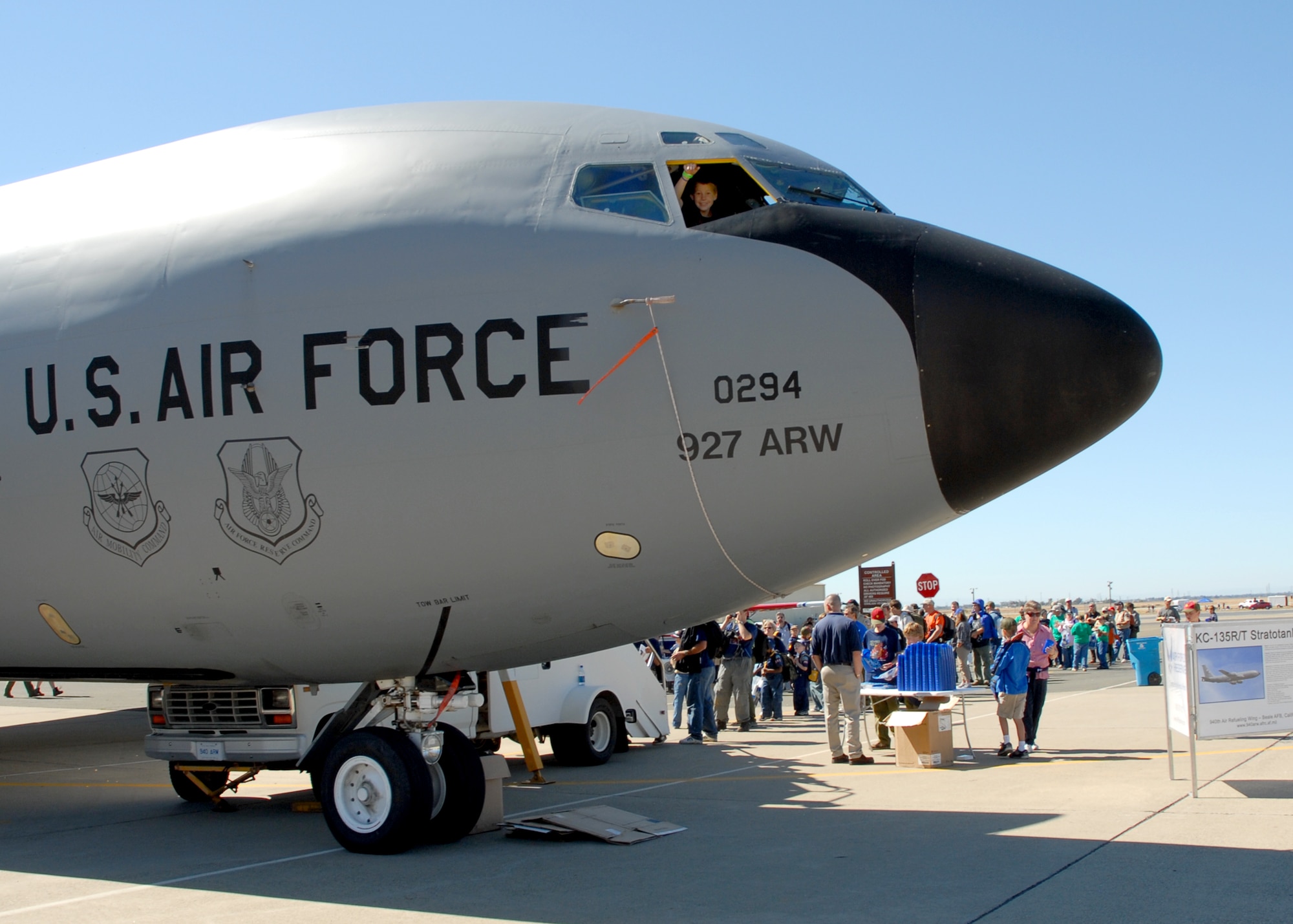 A Boy Scout waves from the cockpit of an Air Force Reserve KC-135 Stratotanker, while other scouts and their families wait to tour the jet Sept. 29, 2007 at Beale Air Force Base, Calif. The jet, which is owned by the 940th Air Refueling Wing at Beale, was only one of many displays the 7,000 scouts saw during the Boy Scout Expo at the base Sept. 28-30. (U.S. Air Force photo/Stacey Knott)