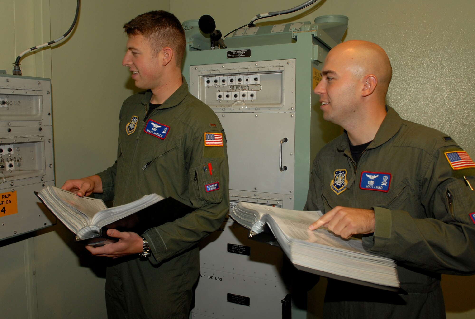 Second Lt. Mark Andrews, 319th Missile Squadron, and 1st Lt. Matt Lord, 90th Operations Group, check for popped circuit breakers during the inspection (Courtesy photo).