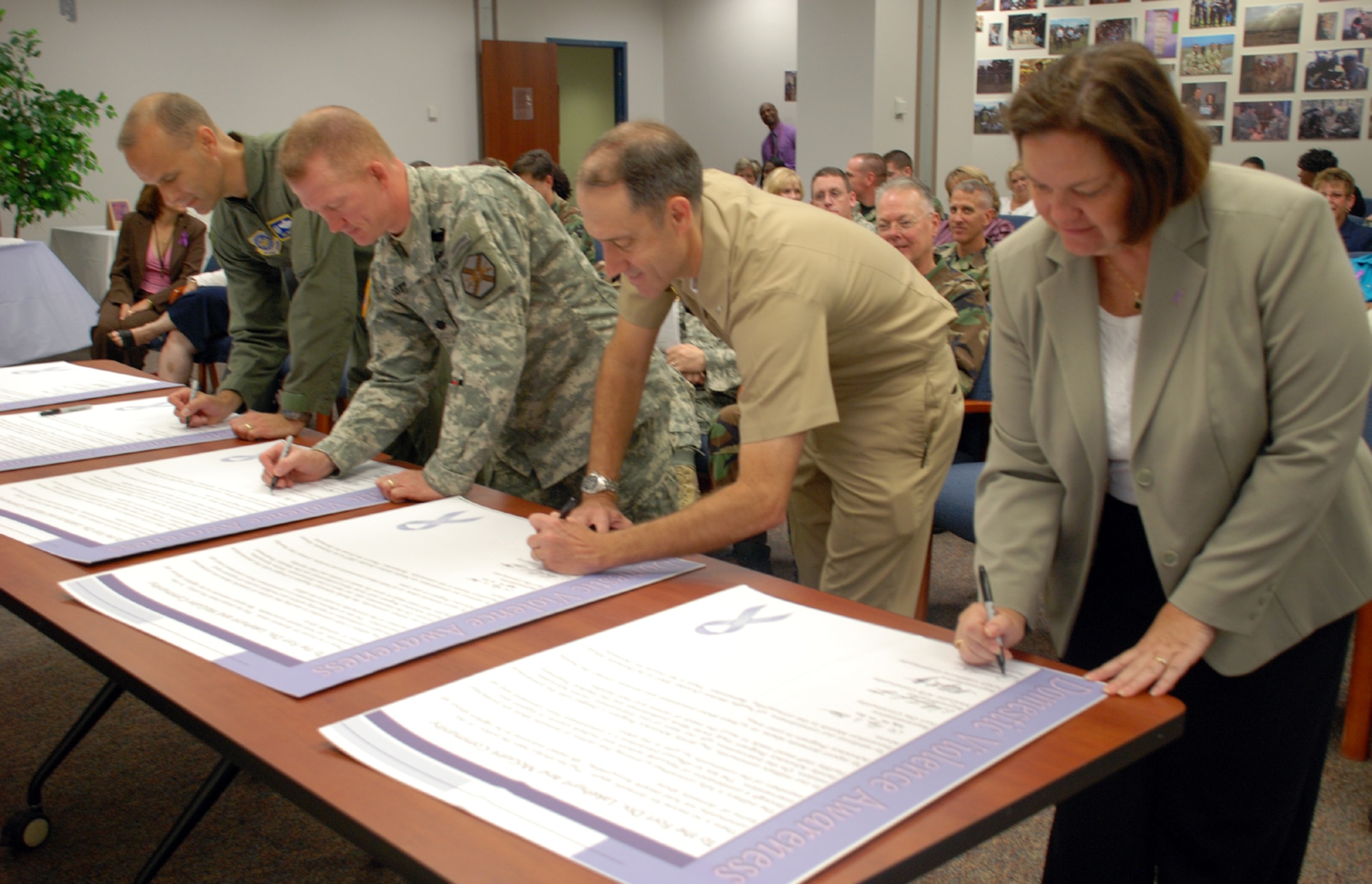 Left to right, Col. Bill Spacy, 305th Air Mobility Wing vice commander, Lt. Col. Roger Cotton, Fort Dix deputy commander, Capt. Phillip Beachy, NAES Lakehurst commanding officer, and Jean Metz, Providence House division director, sign the Domestic Violence Proclamation here Oct. 1. October is designated Domestic Violence Awareness Month. (U.S. Air Force photo/Airman 1st Class Rebekah Phy)   