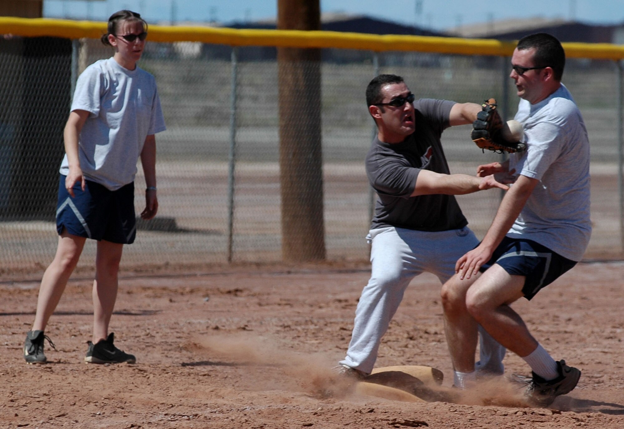 An Airmen from the 49th Operations Support Squadron is called safe at third base during the 49th Aircraft Maintenance Squadron and 49 OSS softball game Sept. 26 for Sports Day. 49 AMXS beat 49 OSS 10-9. (U.S. Air Force photo/Airman 1st Class Heather Stanton)