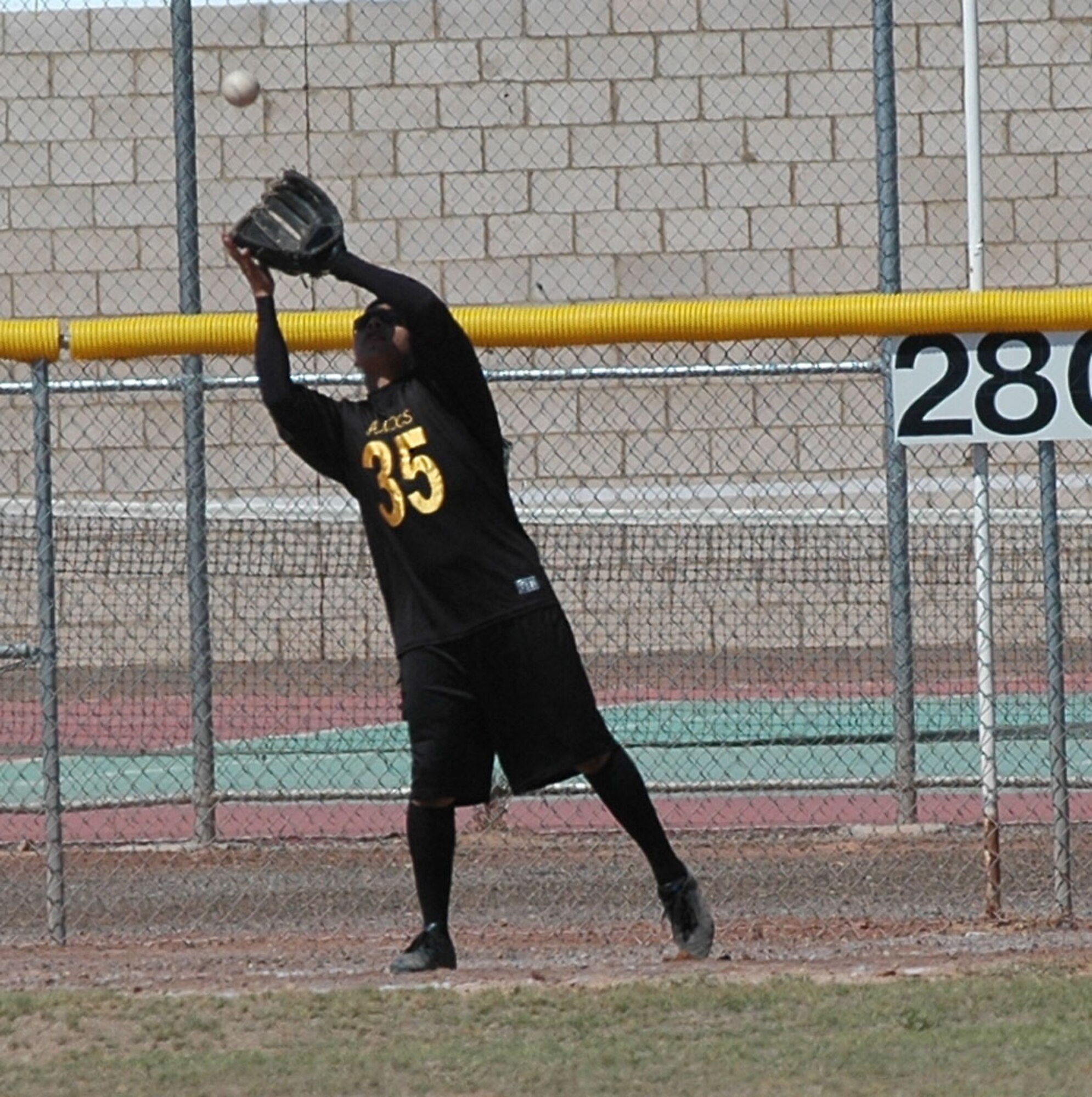 Senior Airman Migel Vega, 49th Aircraft Maintenance Squadron, catches a pop fly to left during the 49 AMXS and 49th Operations Support Squadron softball game Sept. 26 for Sports Day. 49 AMXS beat 49 OSS 10-9. (U.S. Air Force photo/Airman 1st Class Heather Stanton)